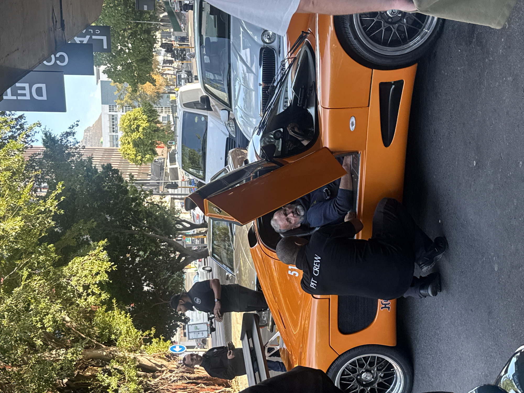 Luxury cars gather with pit crew activity in Cape Town