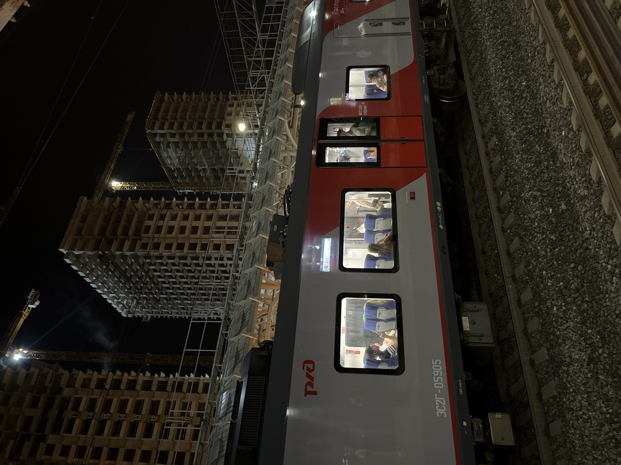 RZhD trains at a Moscow station, construction looming in the background