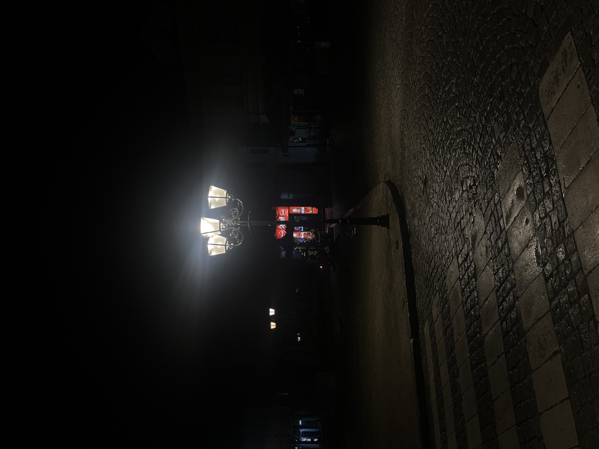 Nighttime street lamps illuminate cobblestone roads in Tryavna, Bulgaria