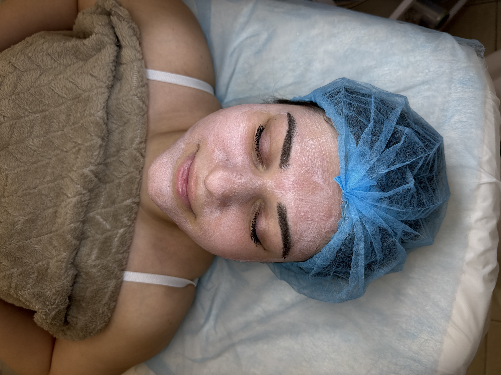 Person receives facial treatment at beauty salon
