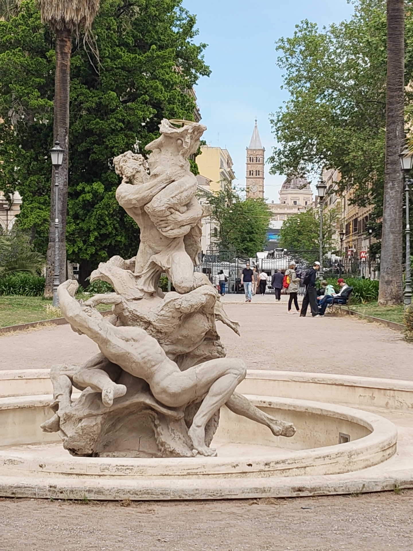 Stone fountain sculpture with human figures observed in Rome park