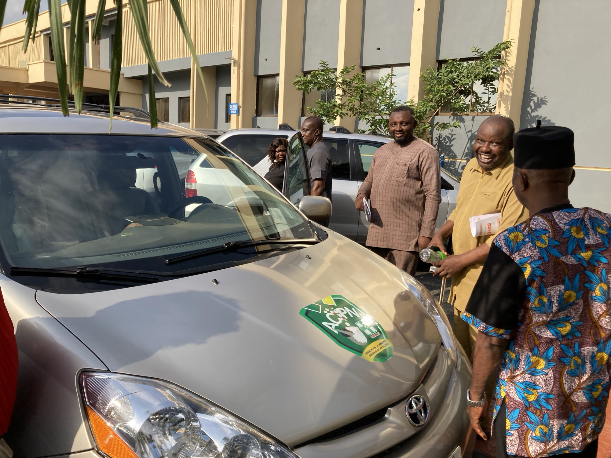 Community meeting and car inspection gathering in Umuahia, Nigeria