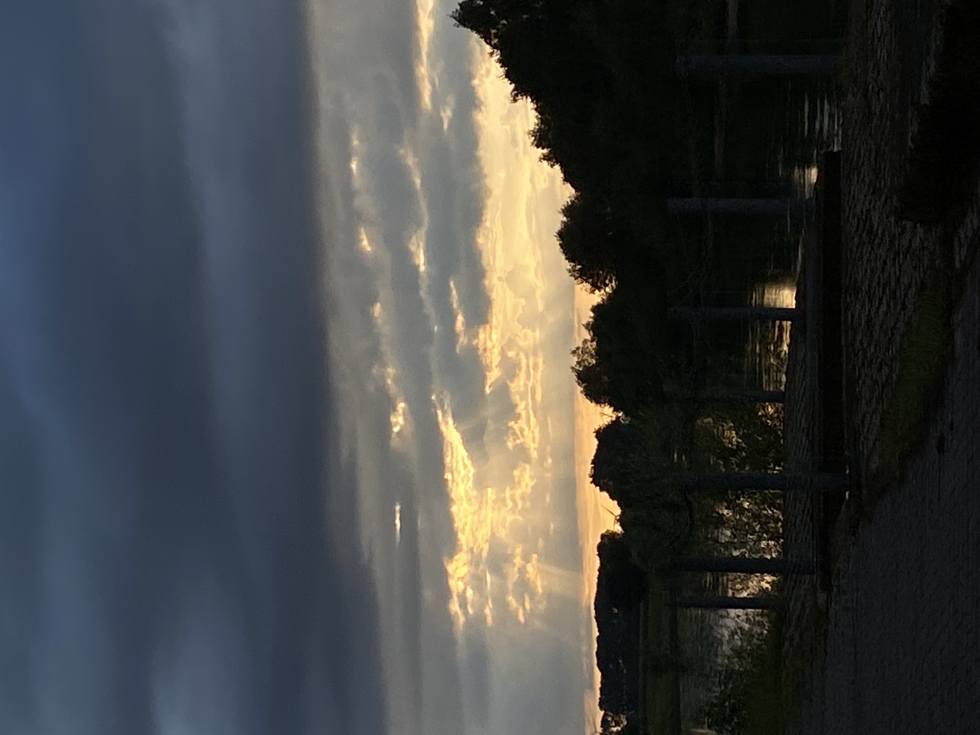 Storm clouds and golden light over the Weser at dusk