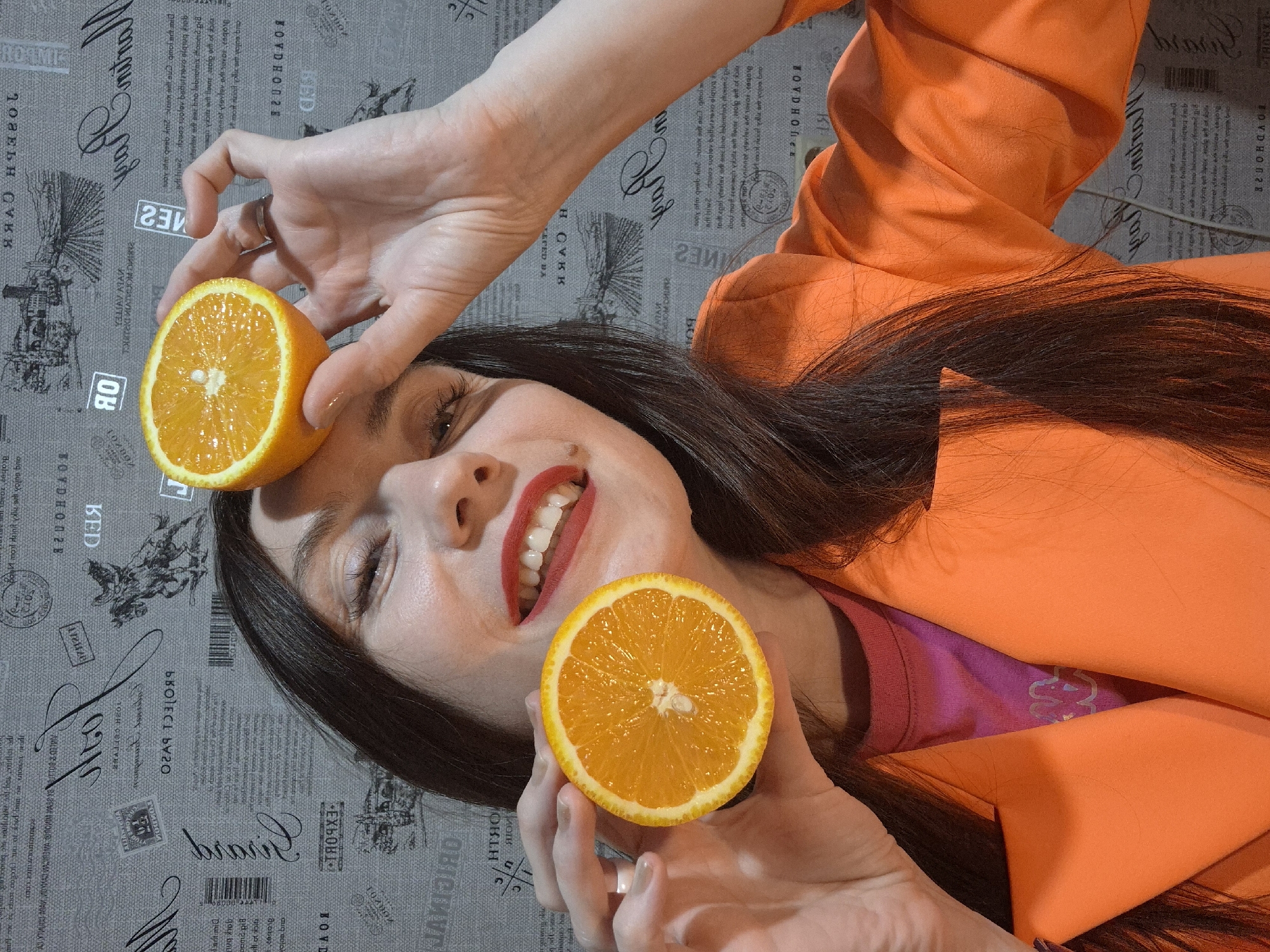 Woman poses with citrus and grapes in playful photo session