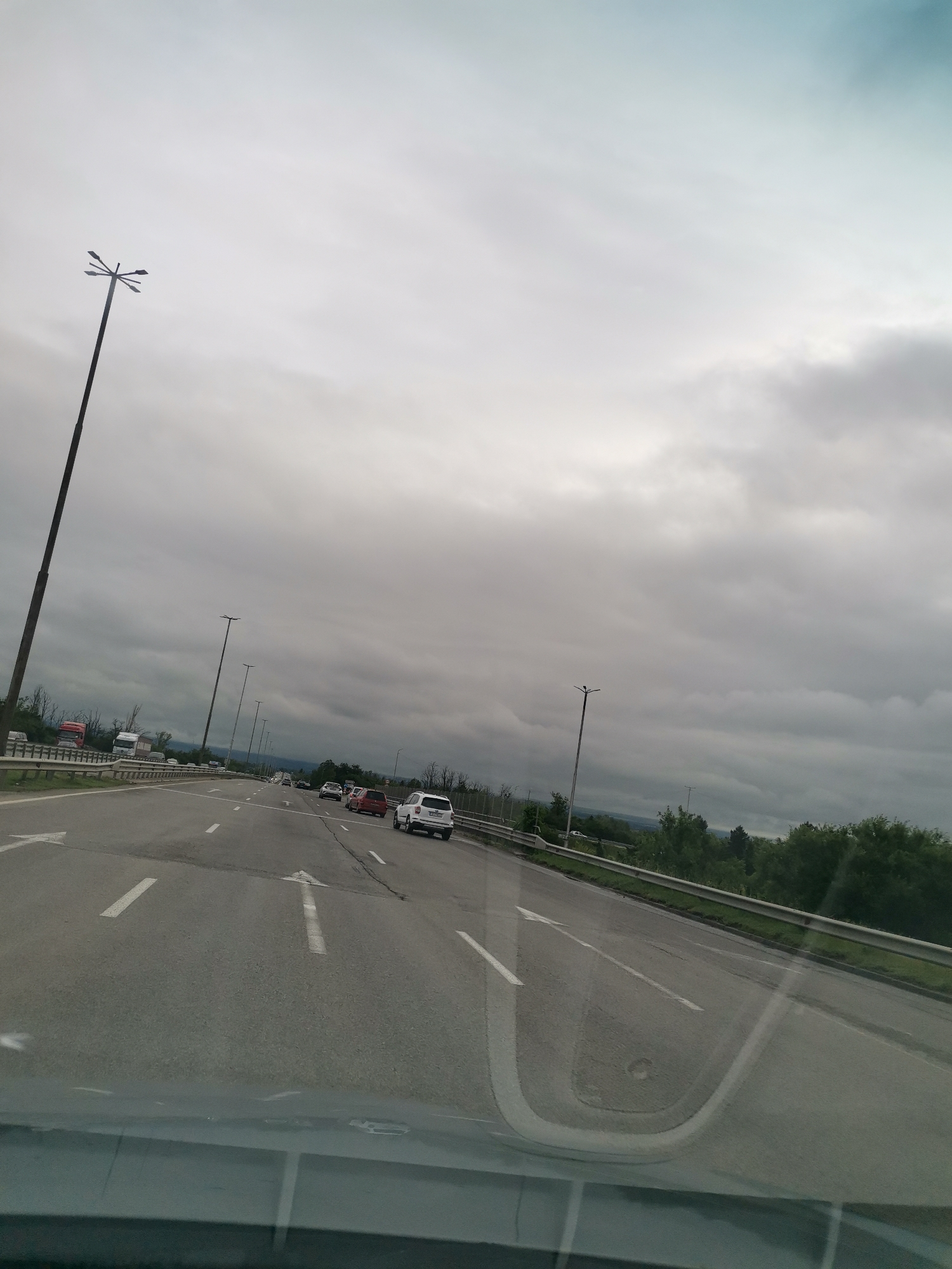 Highway journey documented during overcast morning commute conditions