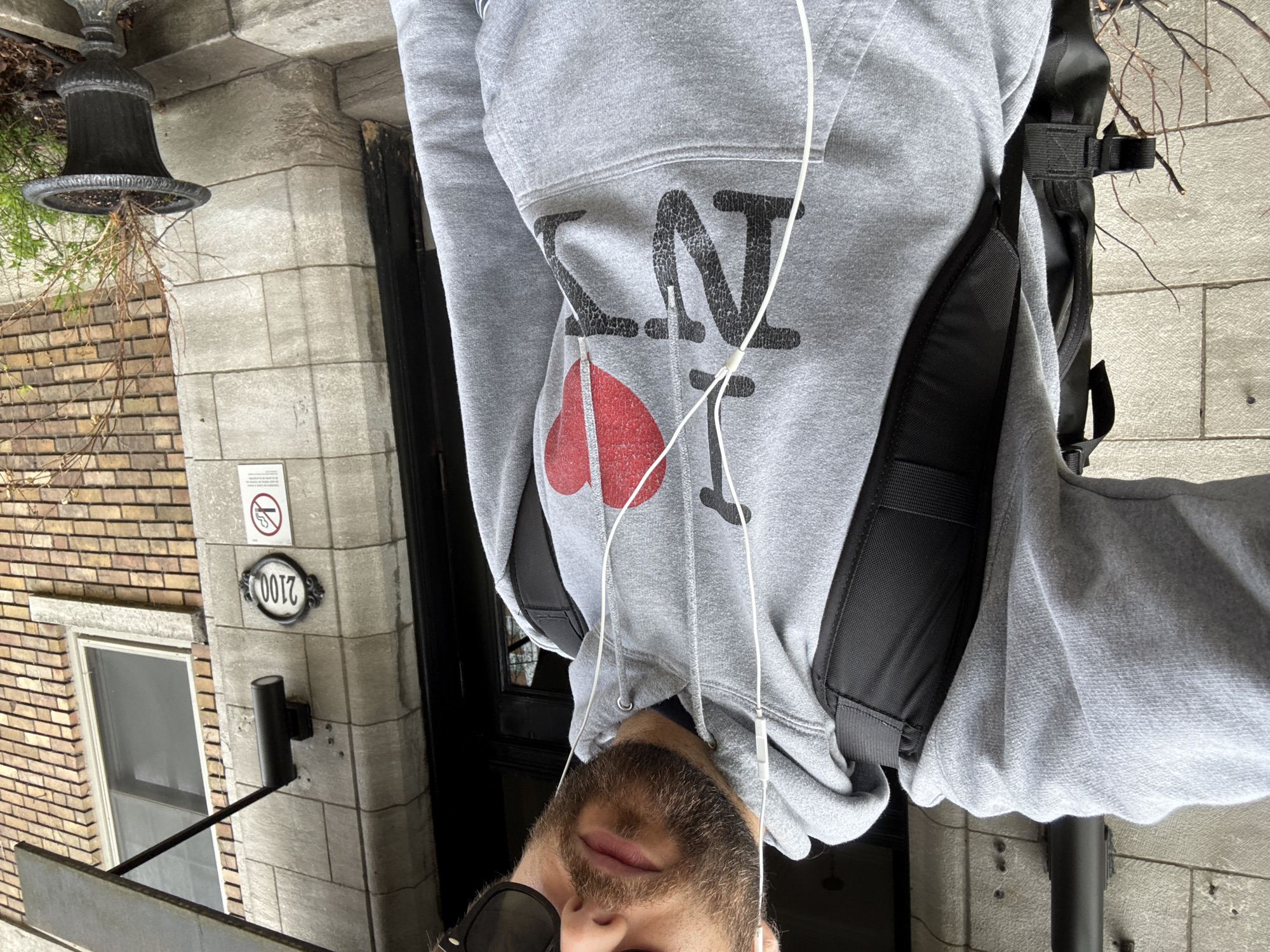 Man in NY-branded hoodie photographed on Montreal street