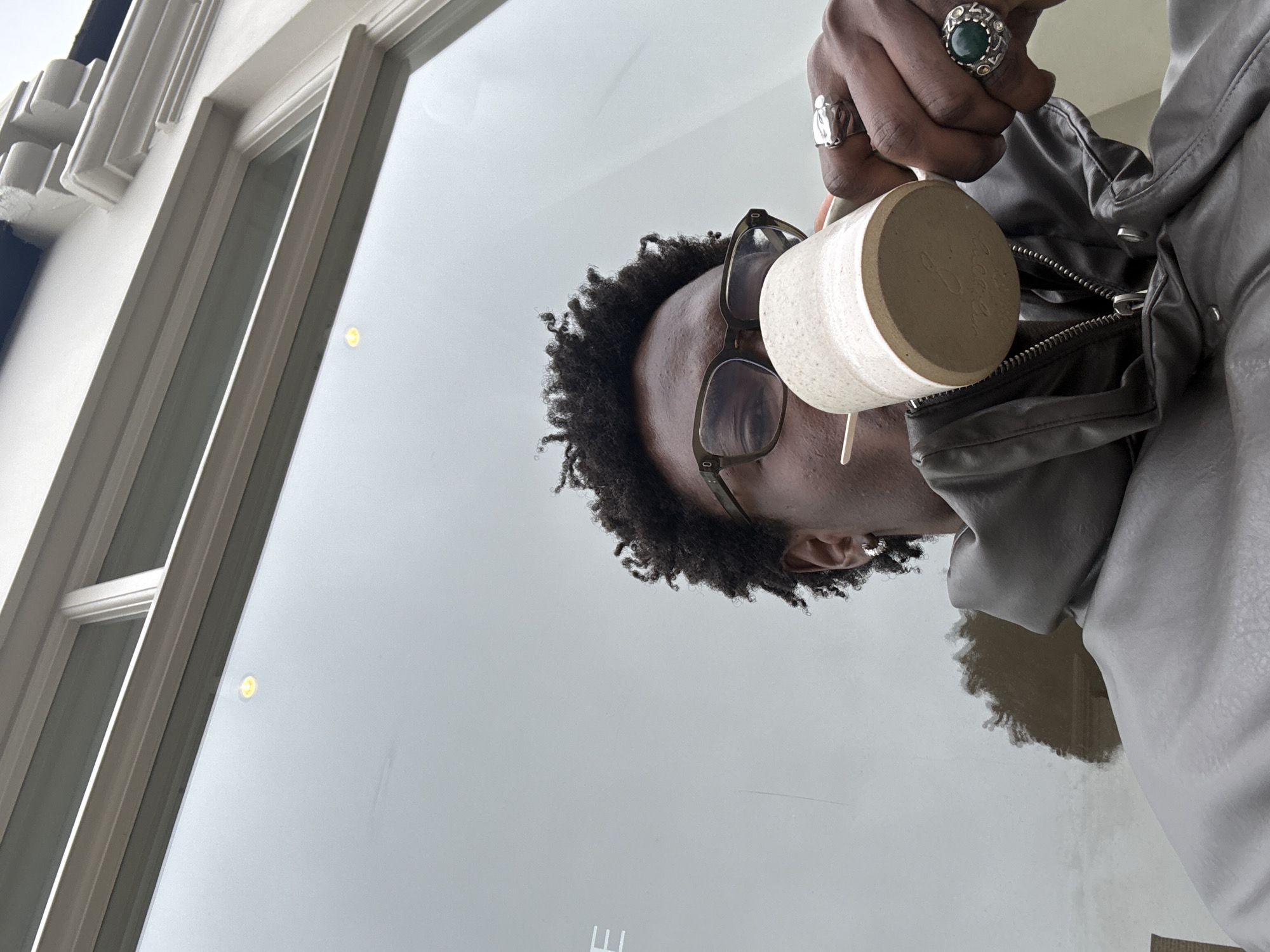 Person enjoys hot drink on London street