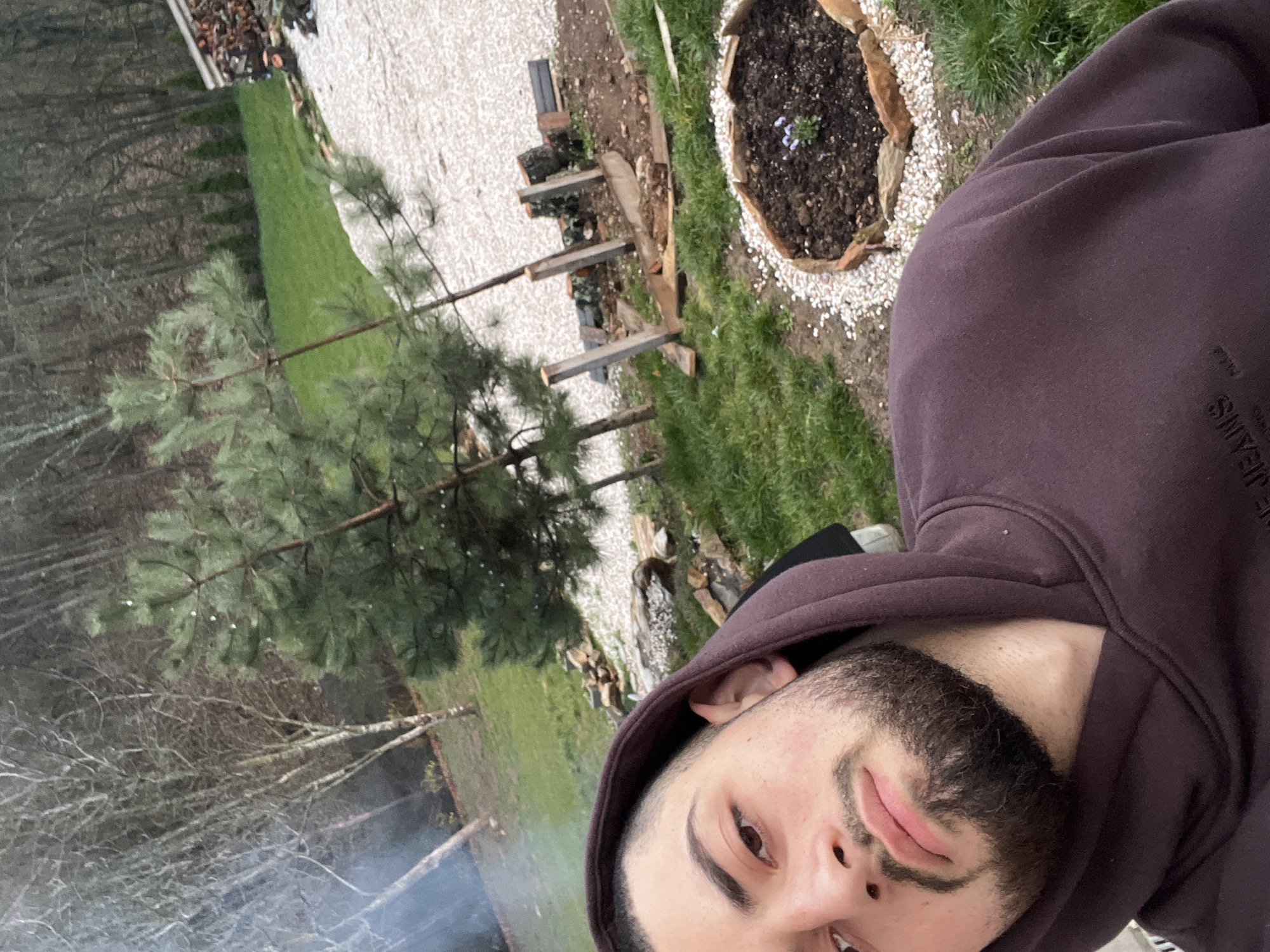 Man takes selfie in Bulgarian backyard with smoke visible