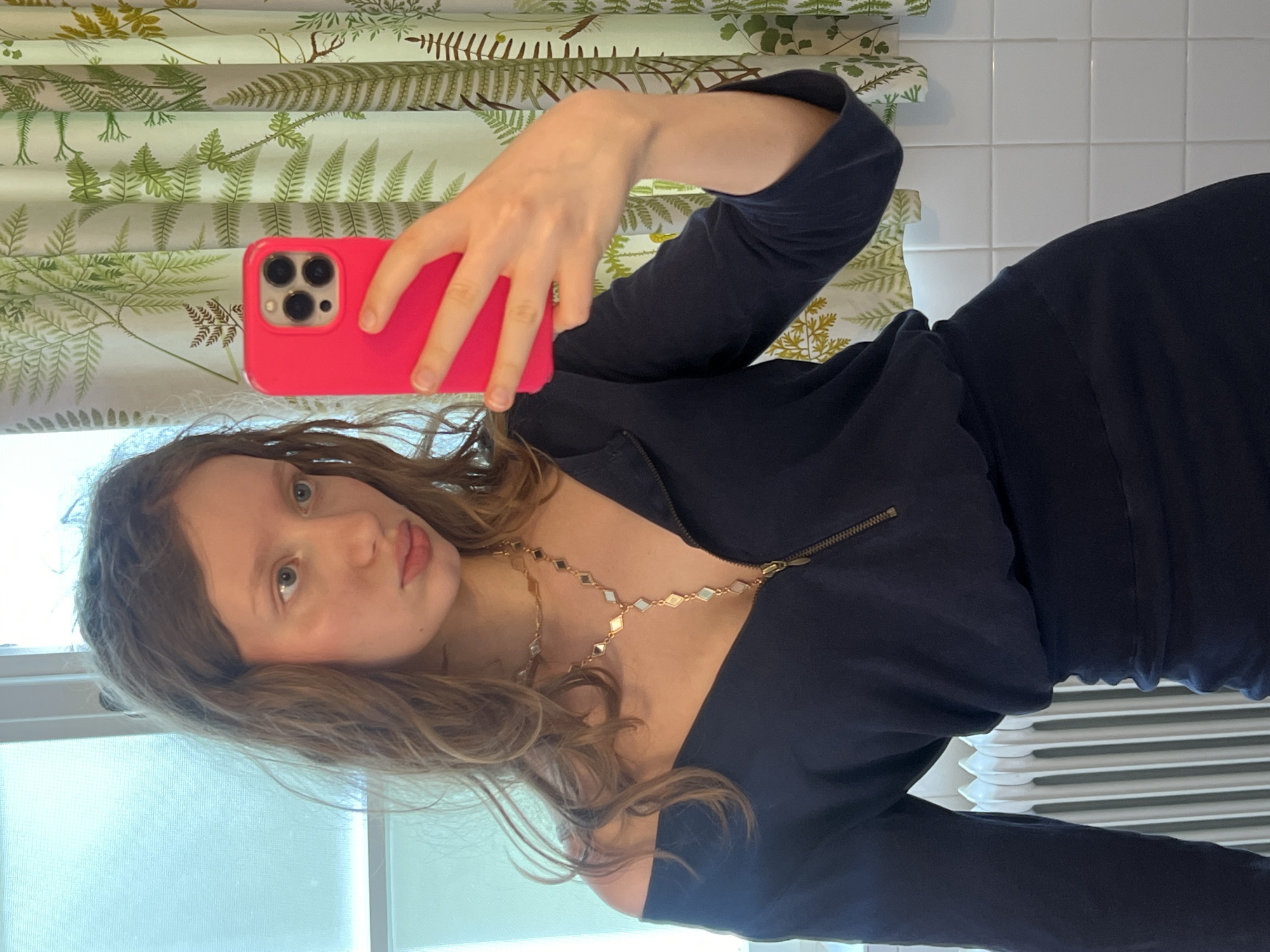 Woman takes bathroom selfie with pink iPhone in Vienna