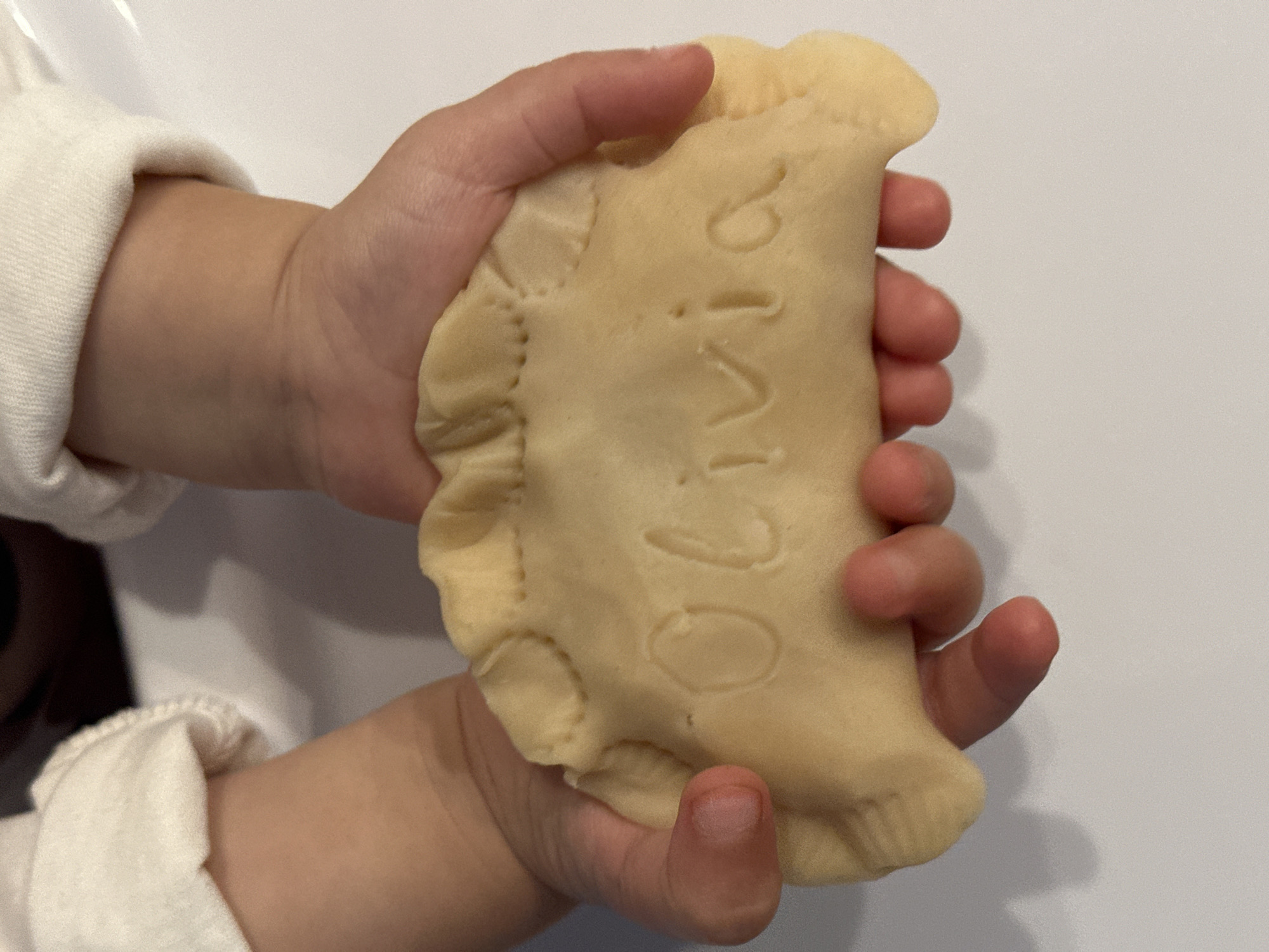 Child enjoys personalized pastry in high chair in Wisła