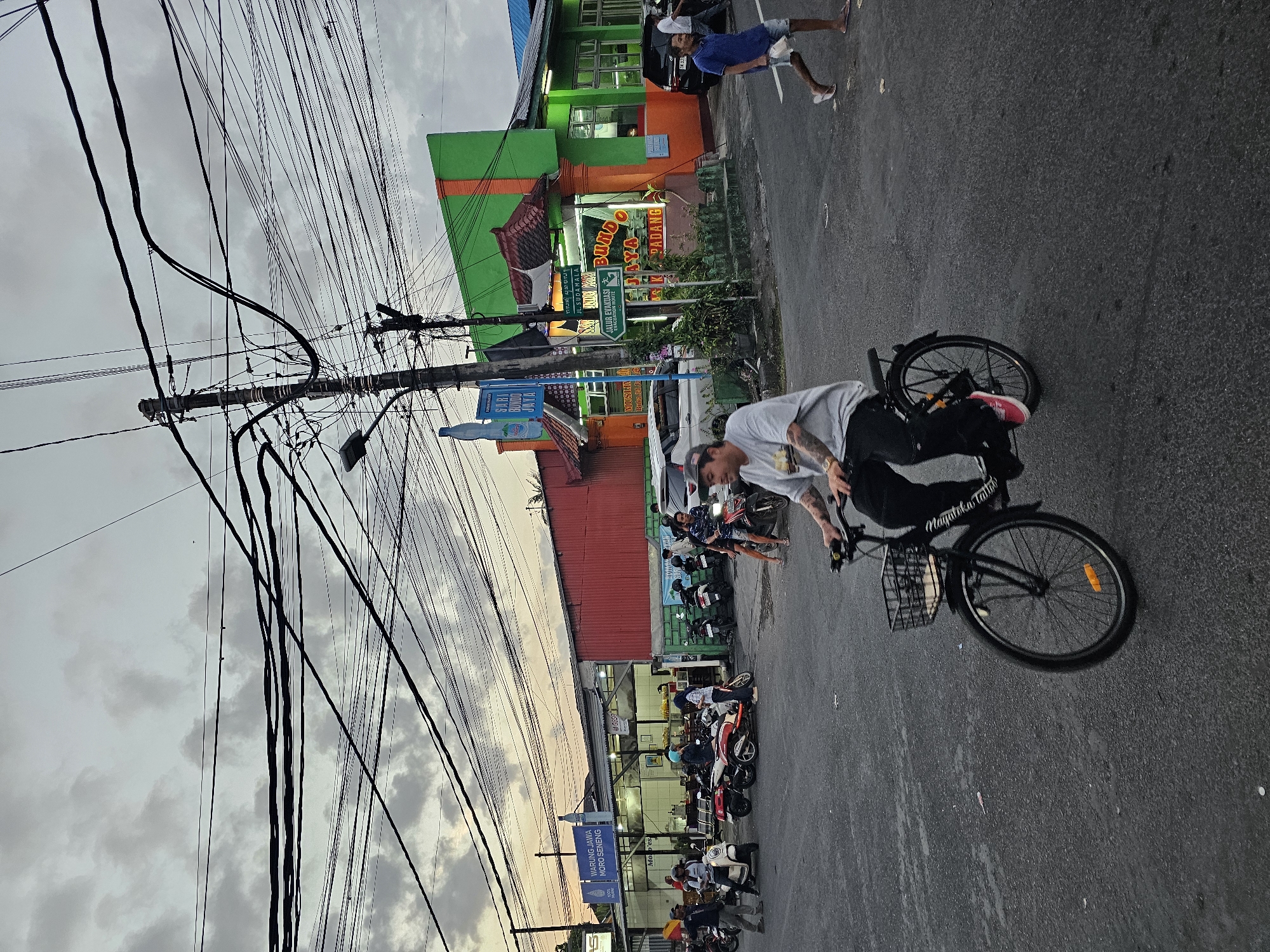 Everyday traffic flows through Denpasar streets on an overcast morning