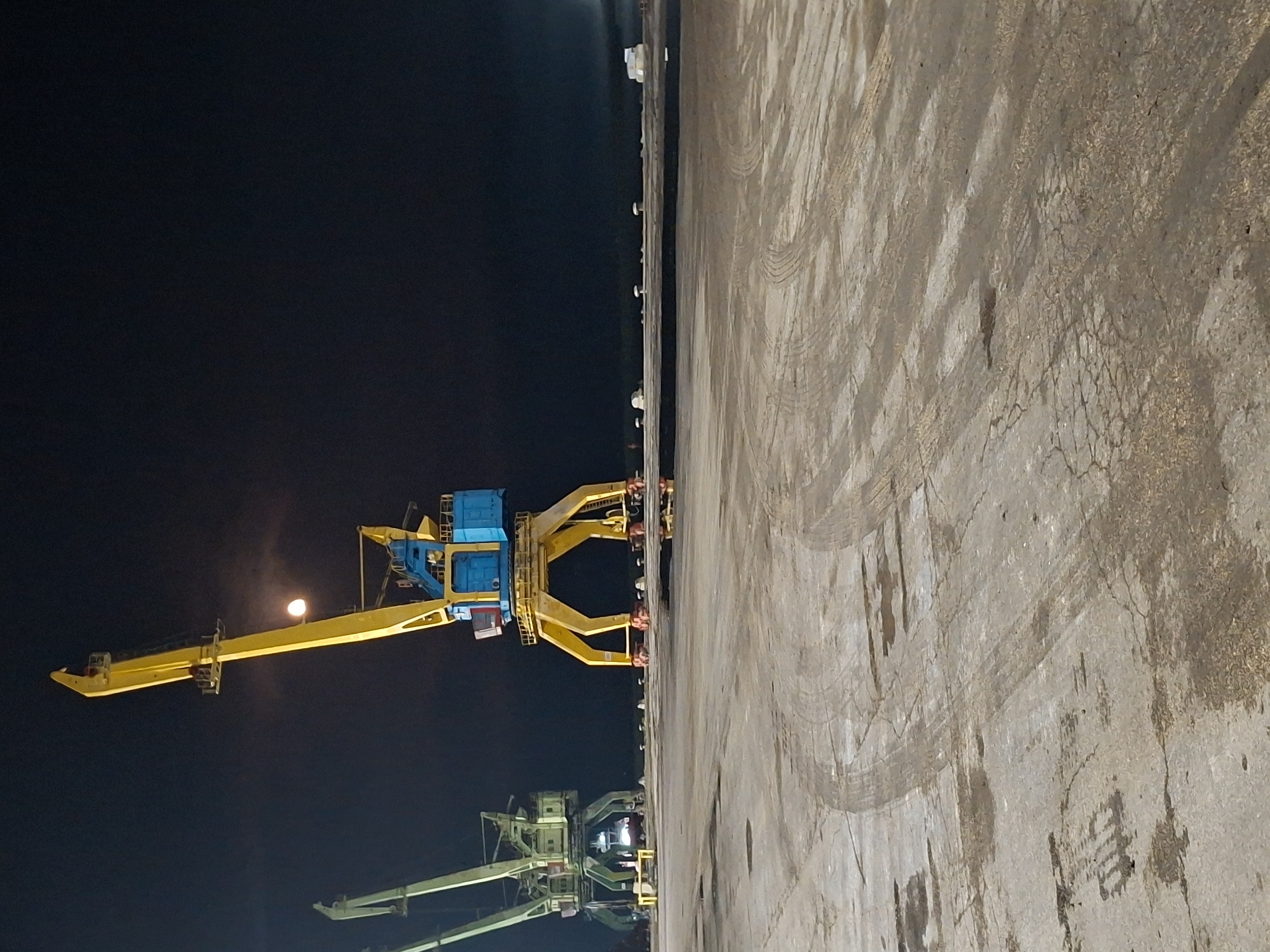 Nighttime cargo operations documented at unidentified industrial port