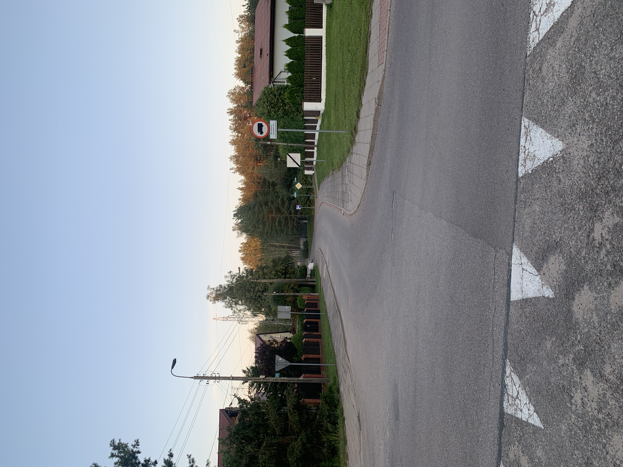 Białystok suburban streets at golden hour, caravan parked nearby