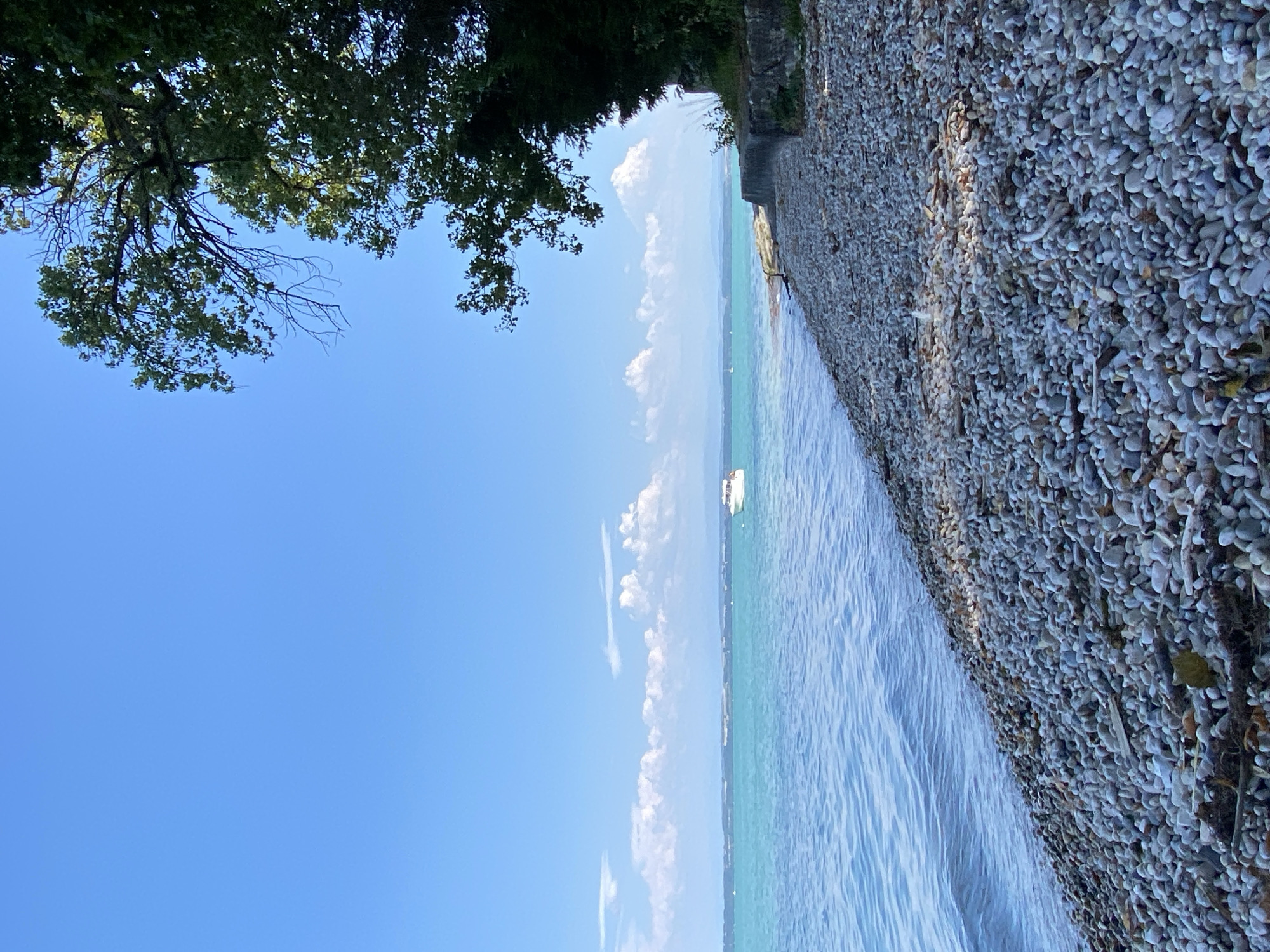 Calm afternoon on Lake Neuchâtel's pebble shore