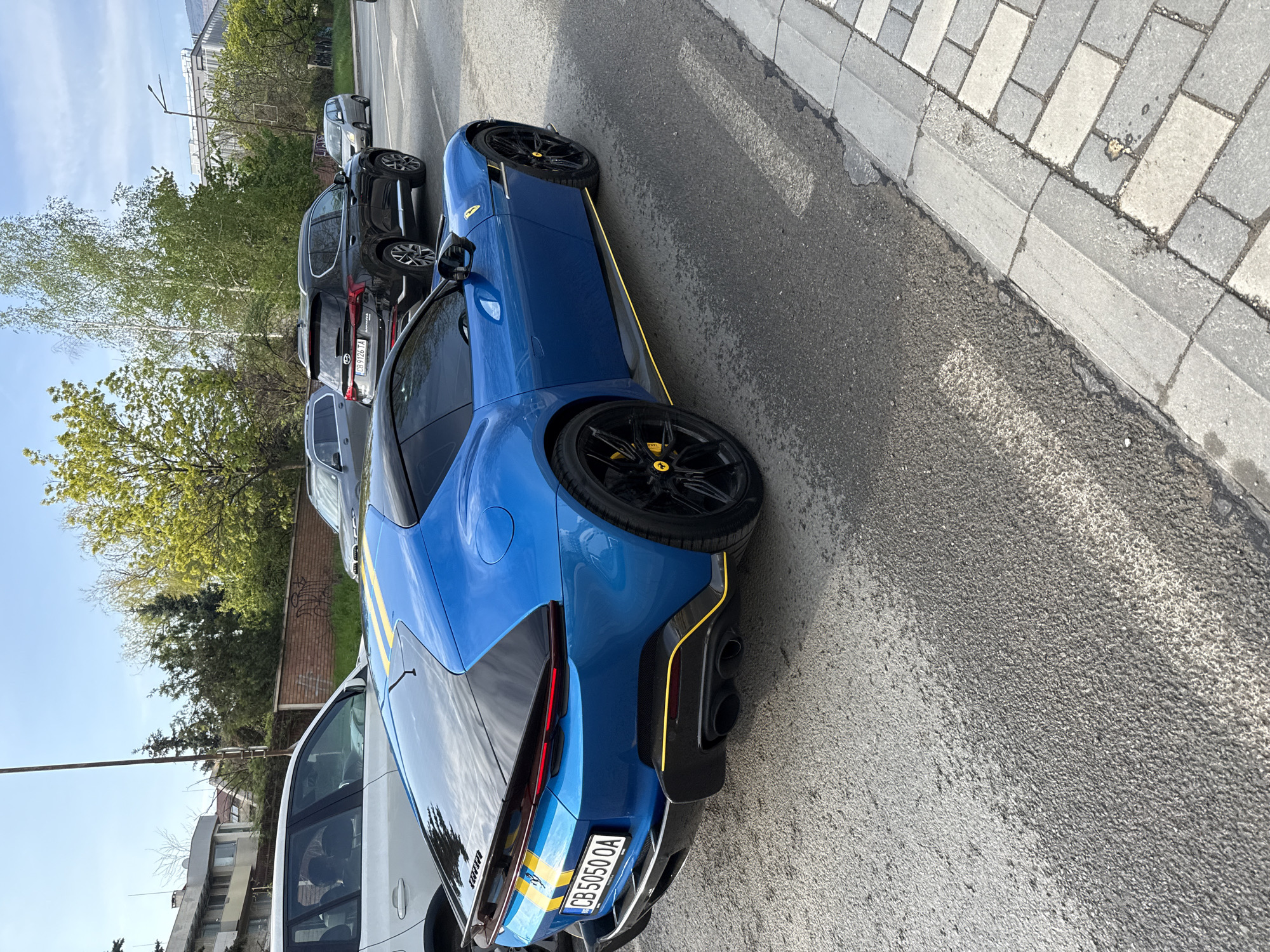 Blue Ferrari spotted on Sofia street amid mountain backdrop