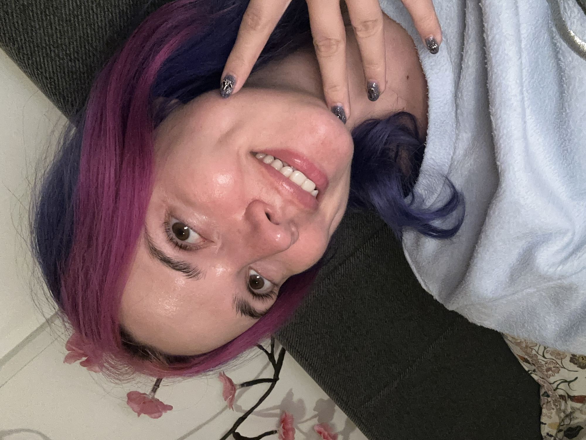 Woman takes colorful-haired selfies on Zagreb couch