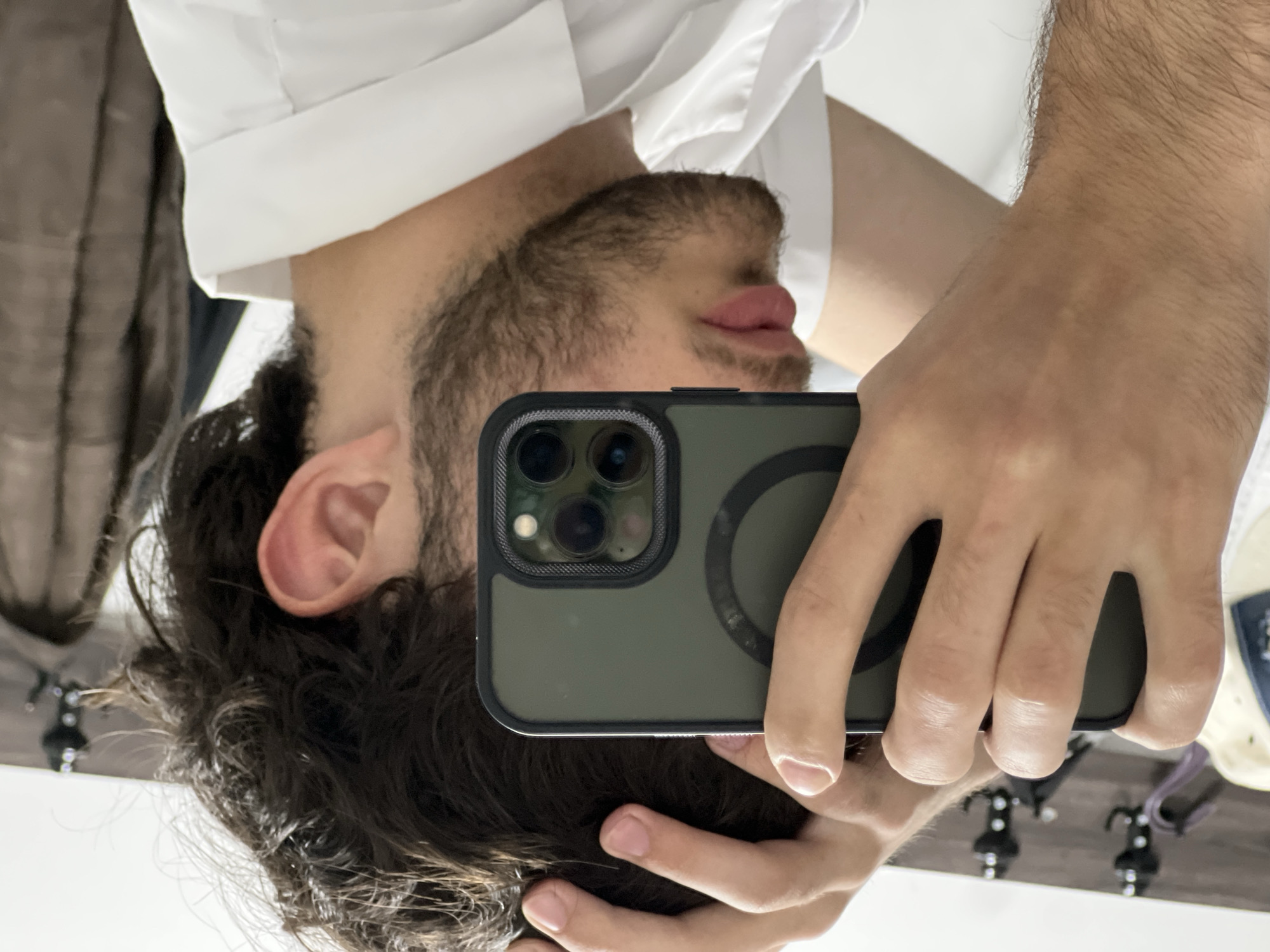 Man takes mirror selfie with iPhone in Yerevan