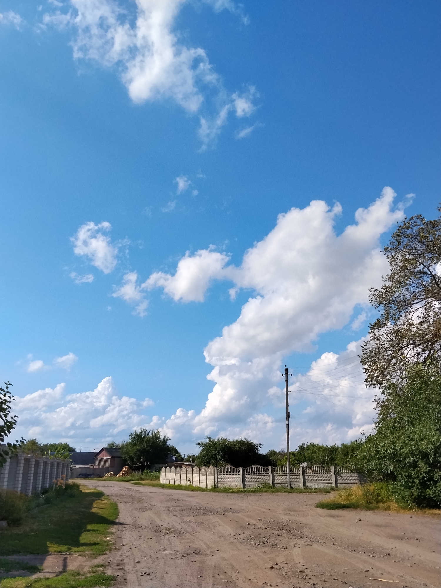 Quiet dirt road through a rural Ukrainian village