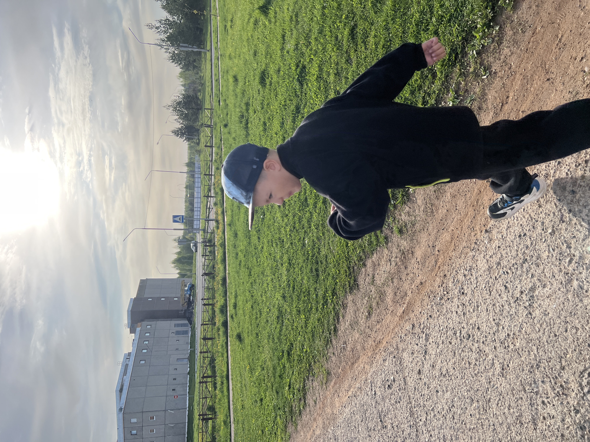 Young person walks dirt path in Марковský early morning