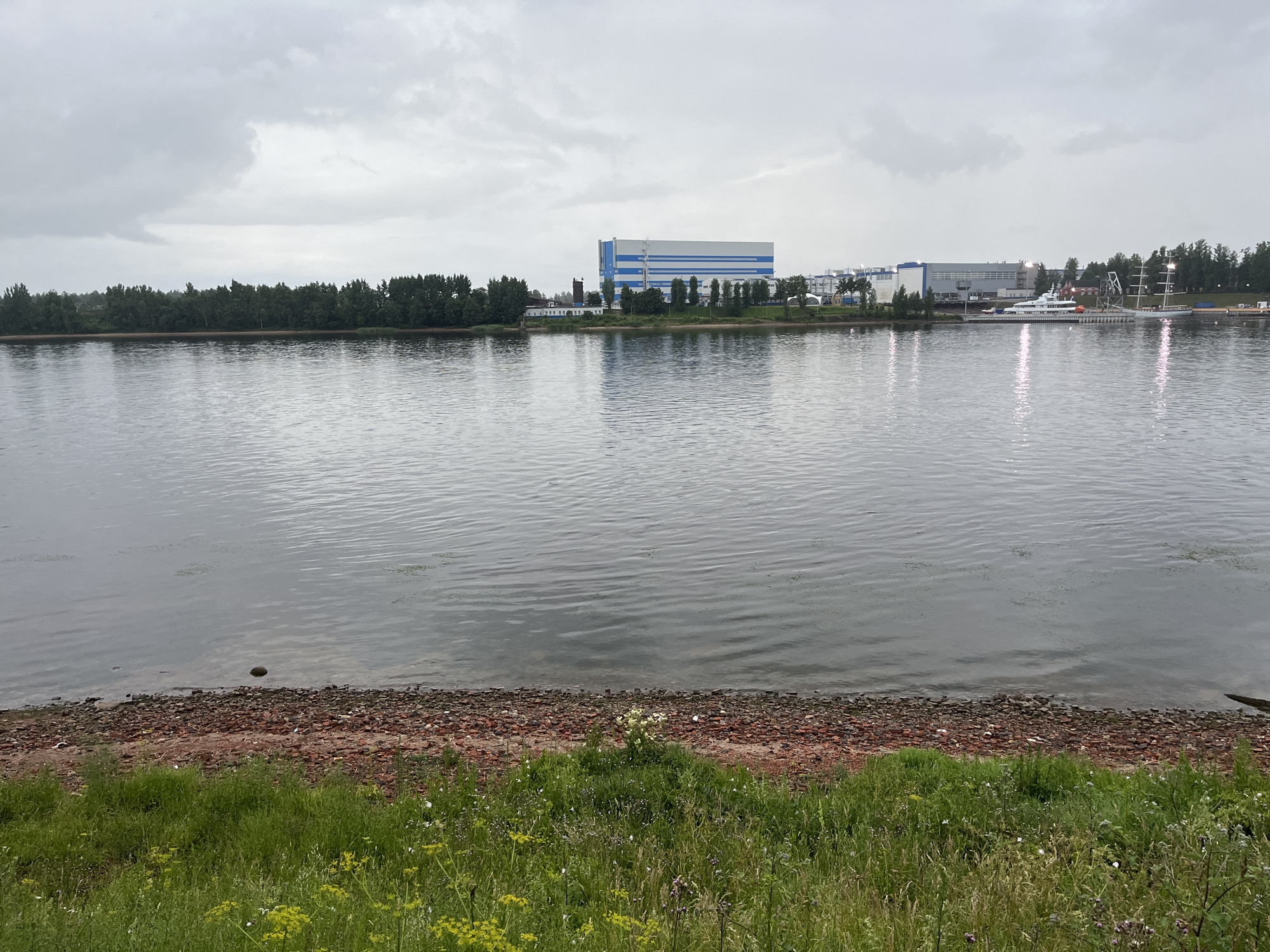 Overcast afternoon at the Neva River near an industrial shipyard