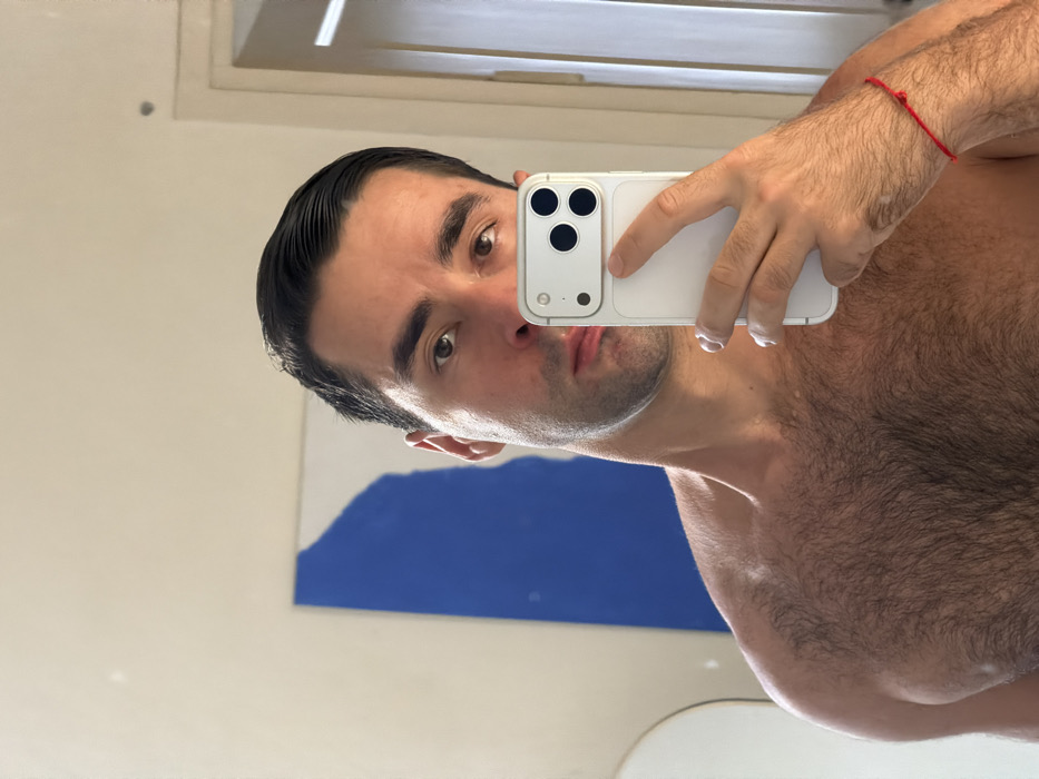 Man takes mirror selfie indoors in Tel-Aviv