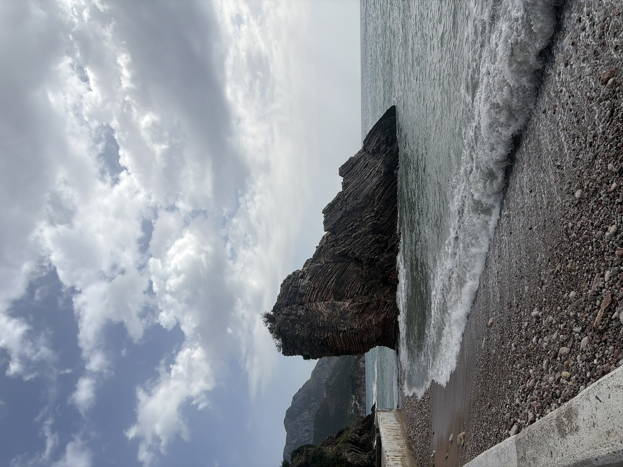 Coastal cliff formations documented by witnesses during overcast afternoon