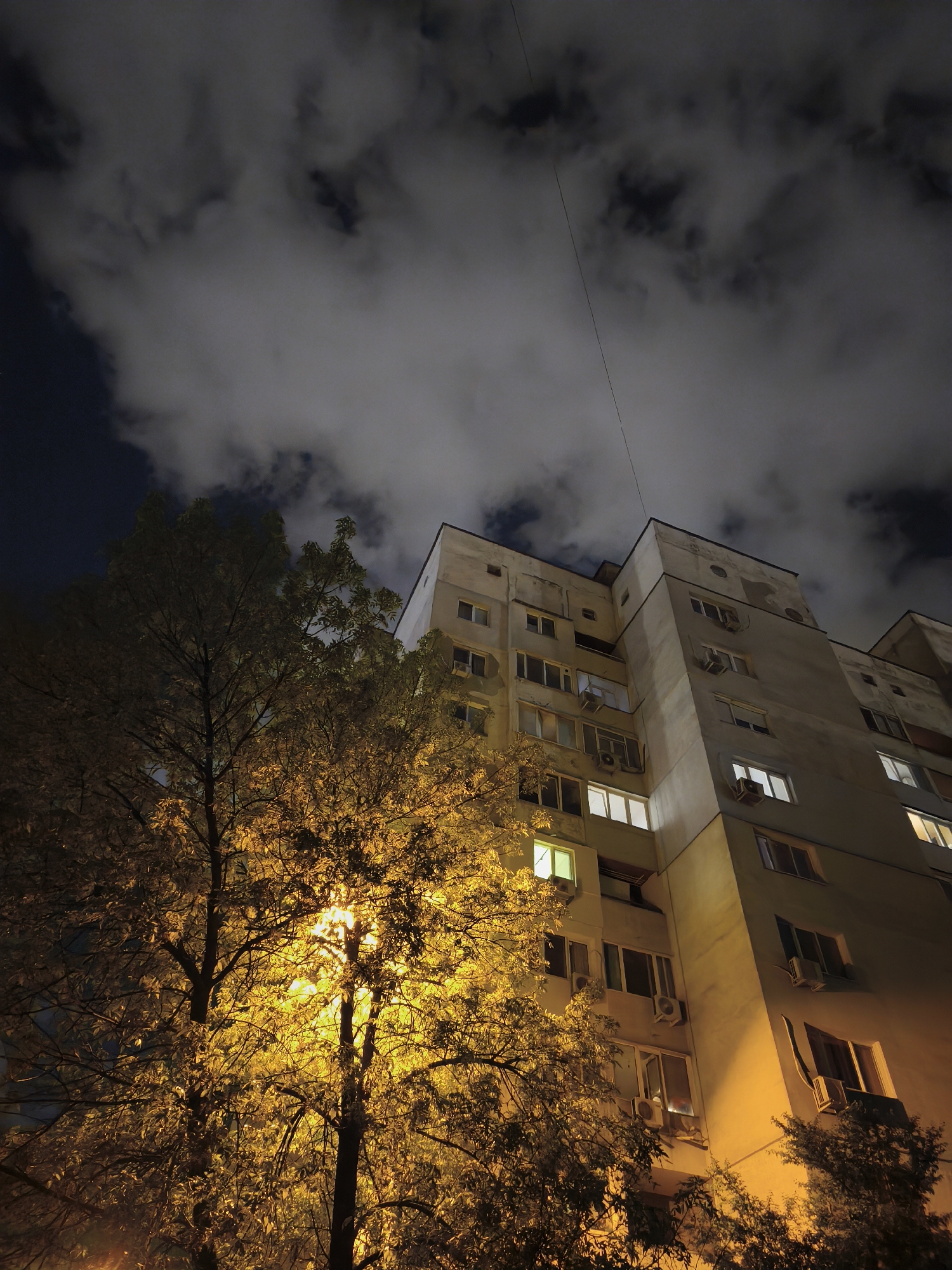 Nighttime view captured of Sofia apartment building under streetlight