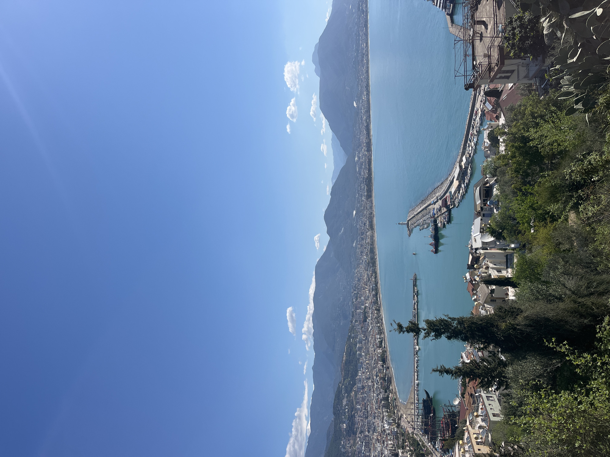 Cruise ship docks at Alanya harbor amid coastal views