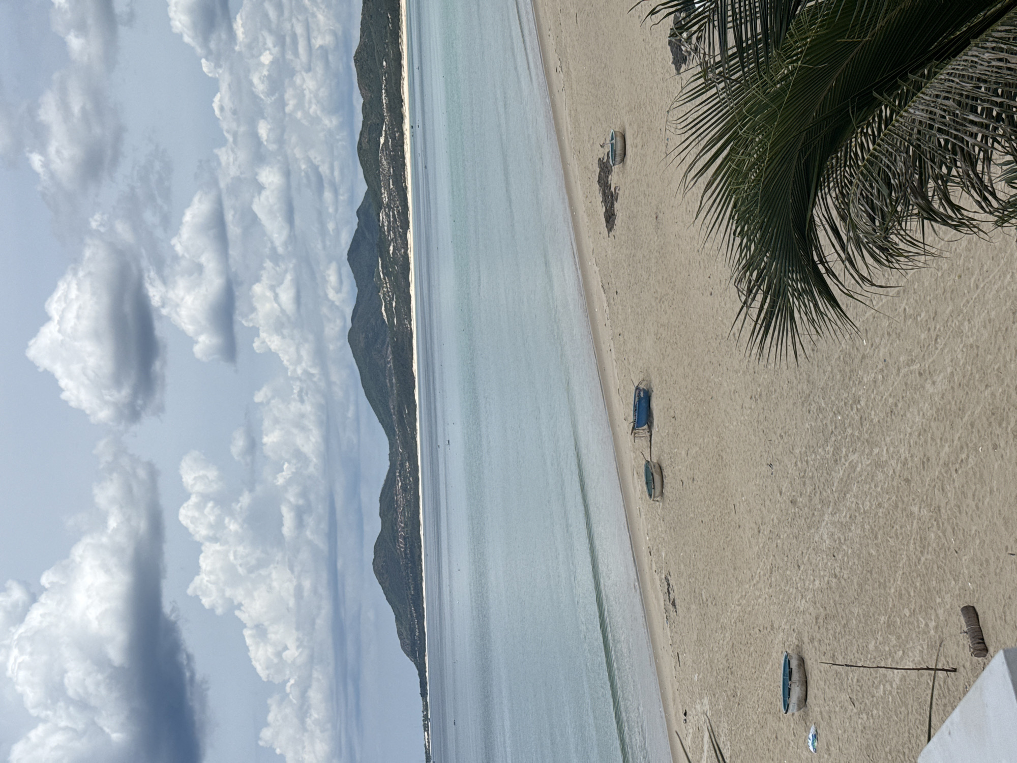 Calm tropical beach and balcony views on a cloudy day
