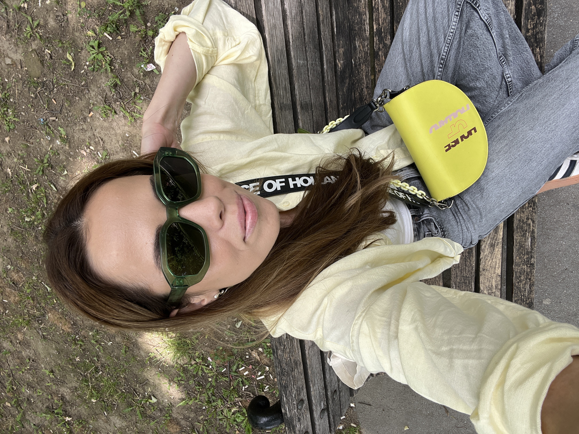 Woman enjoys morning Starbucks drink on Belgrade park bench
