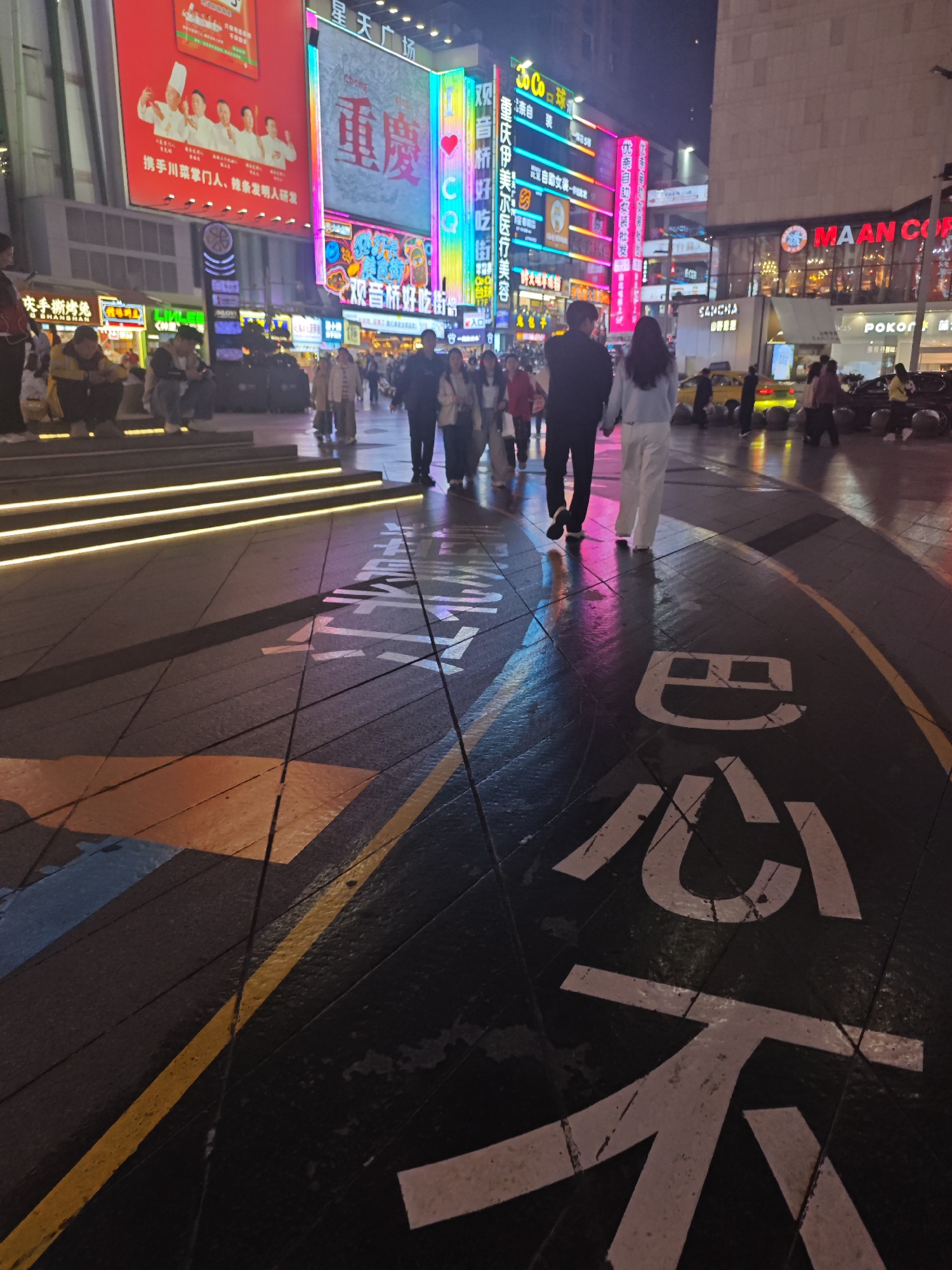 Nighttime commercial district bustling with food vendors, shoppers