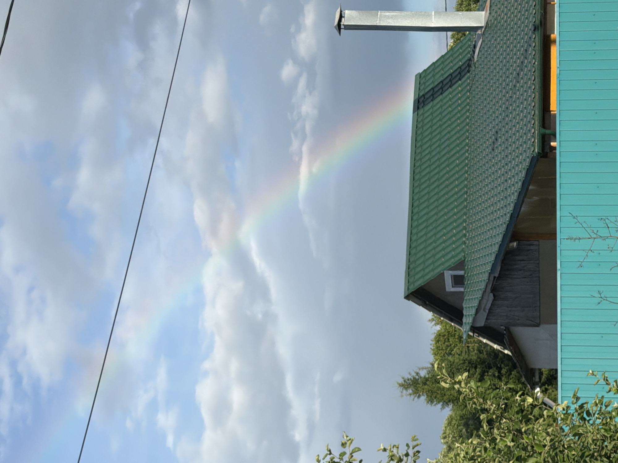 Rainbow over Moscow suburbs, lakes, and a lazy summer afternoon