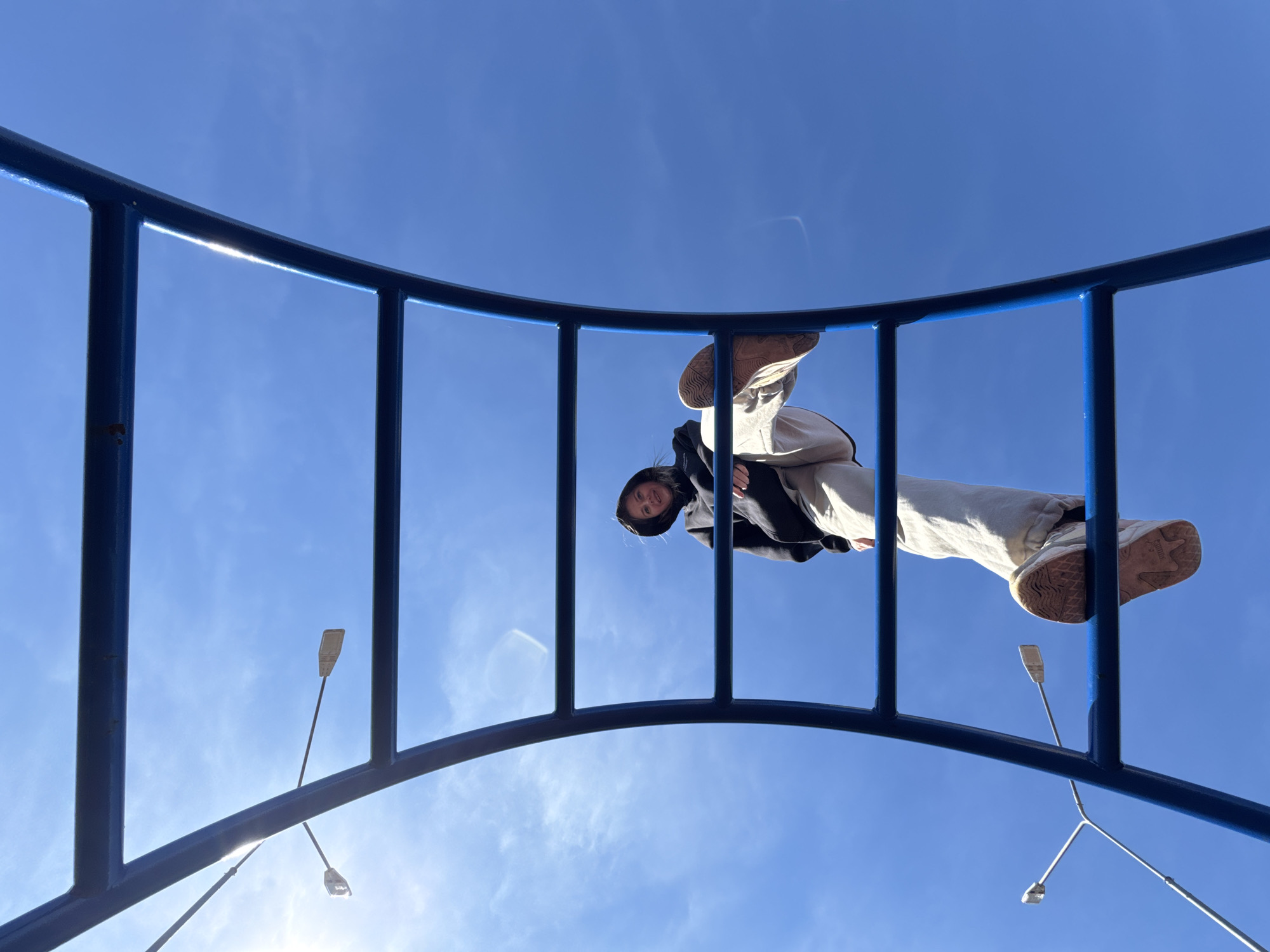 Child plays on colorful playground equipment in Горный, Russia