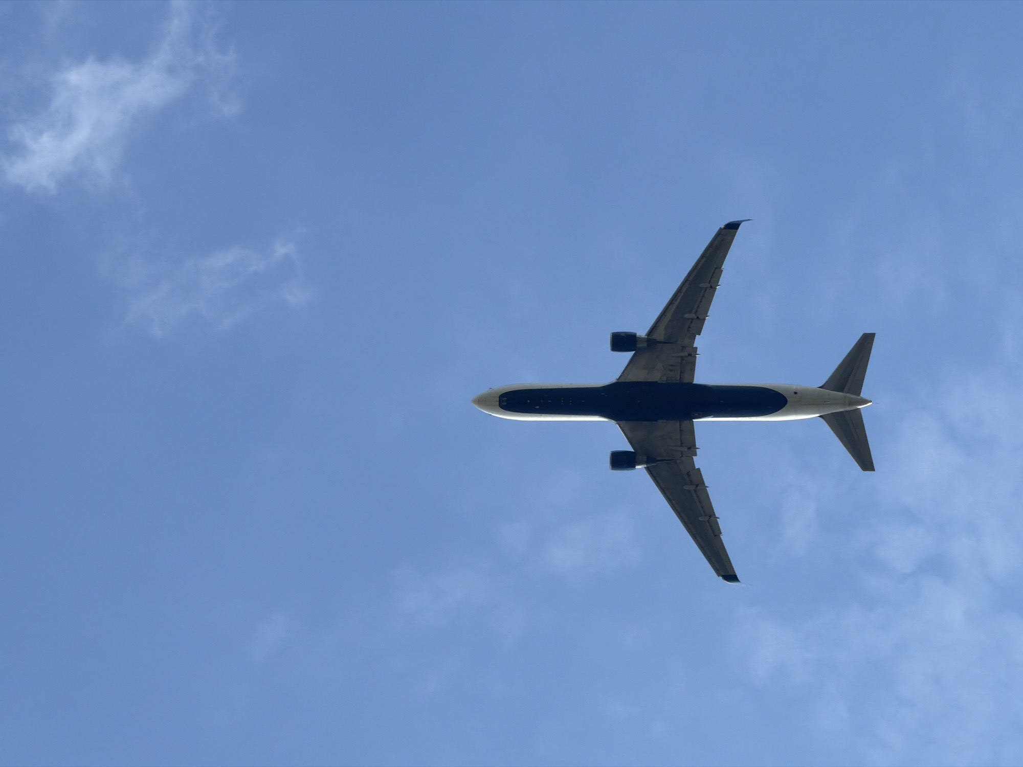 Commercial jet climbs low overhead near Prague, landing gear still down