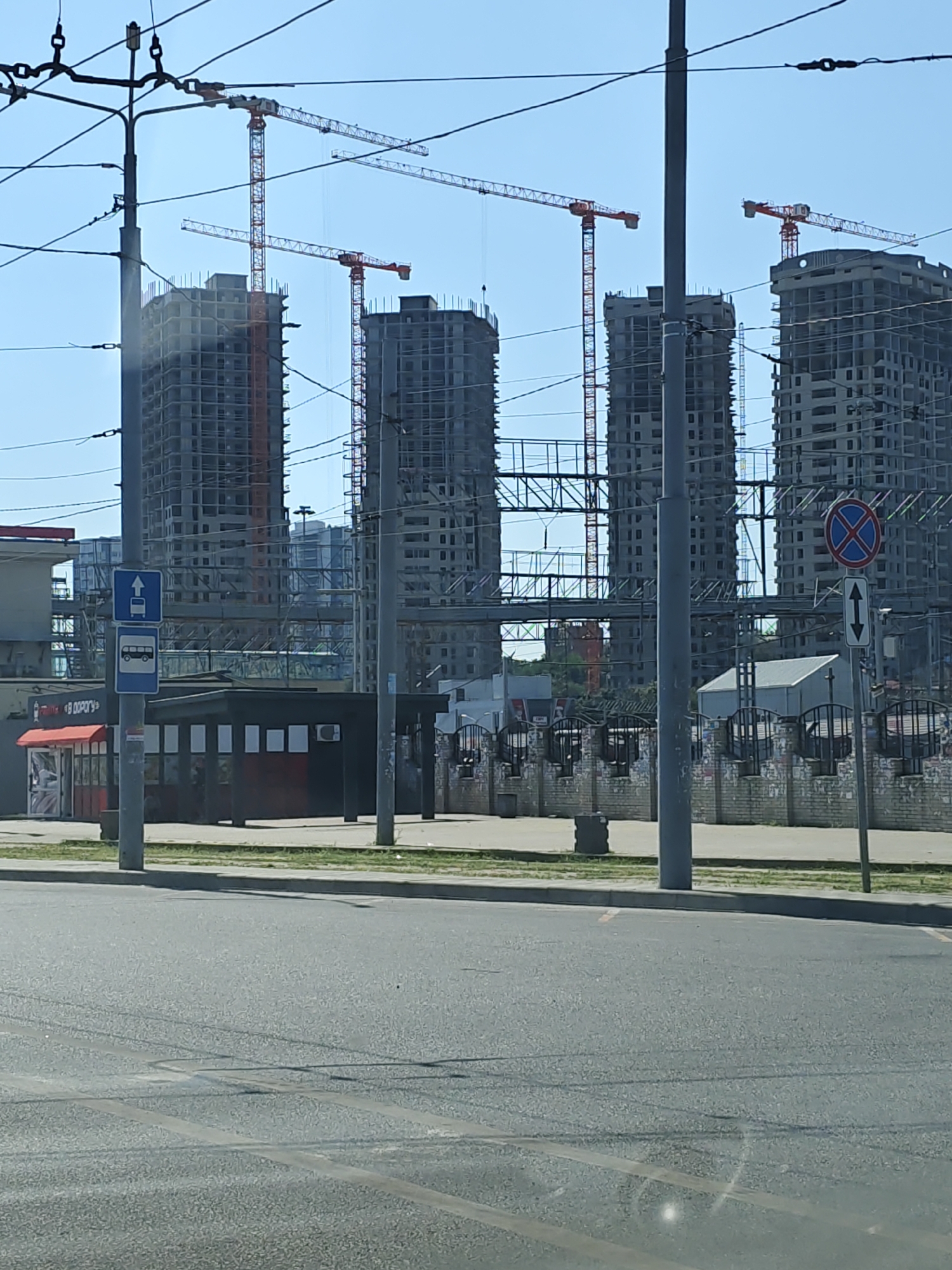 Urban construction zone with parked vehicles and light traffic