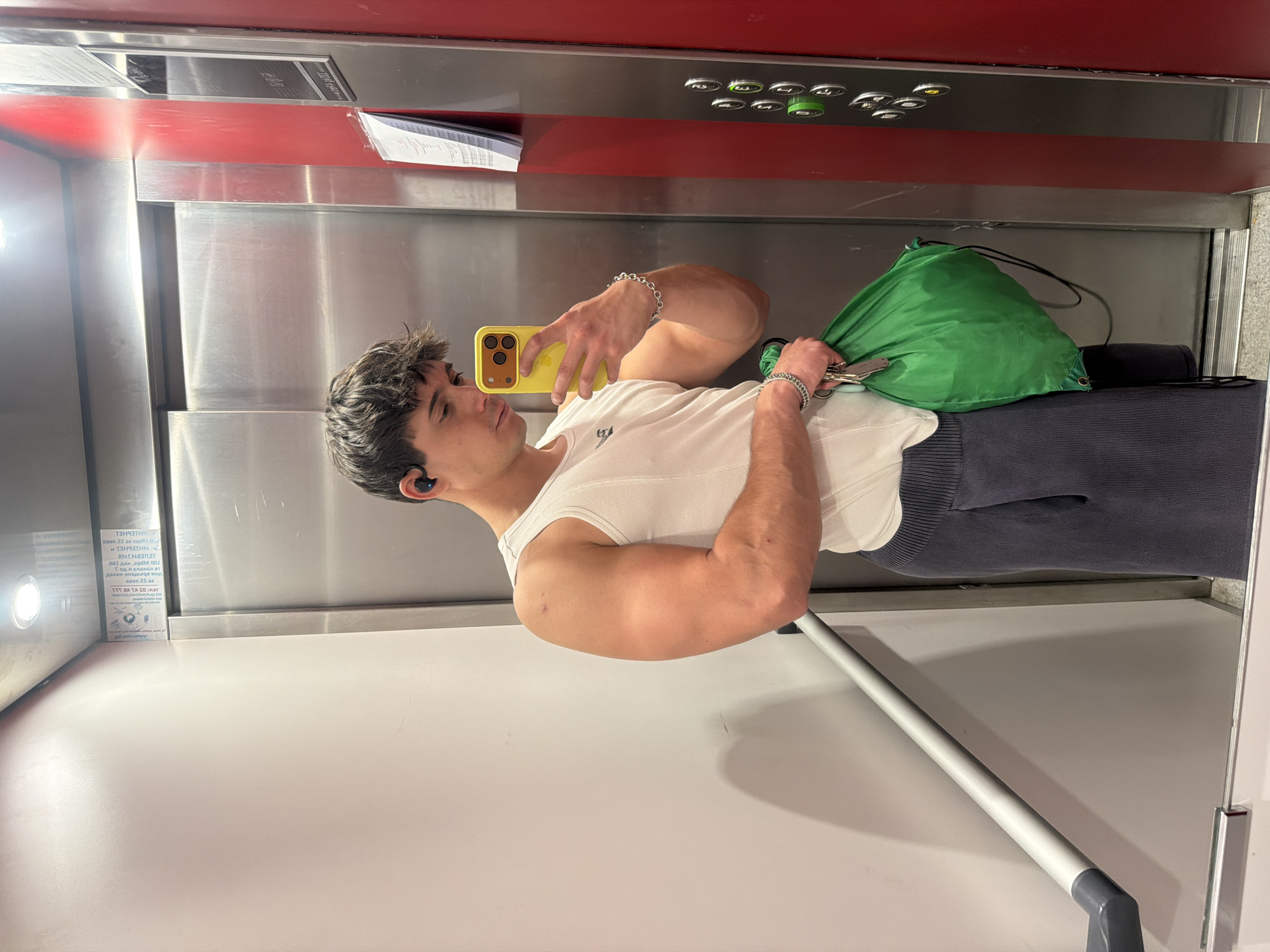Young man takes elevator mirror selfie in Sofia