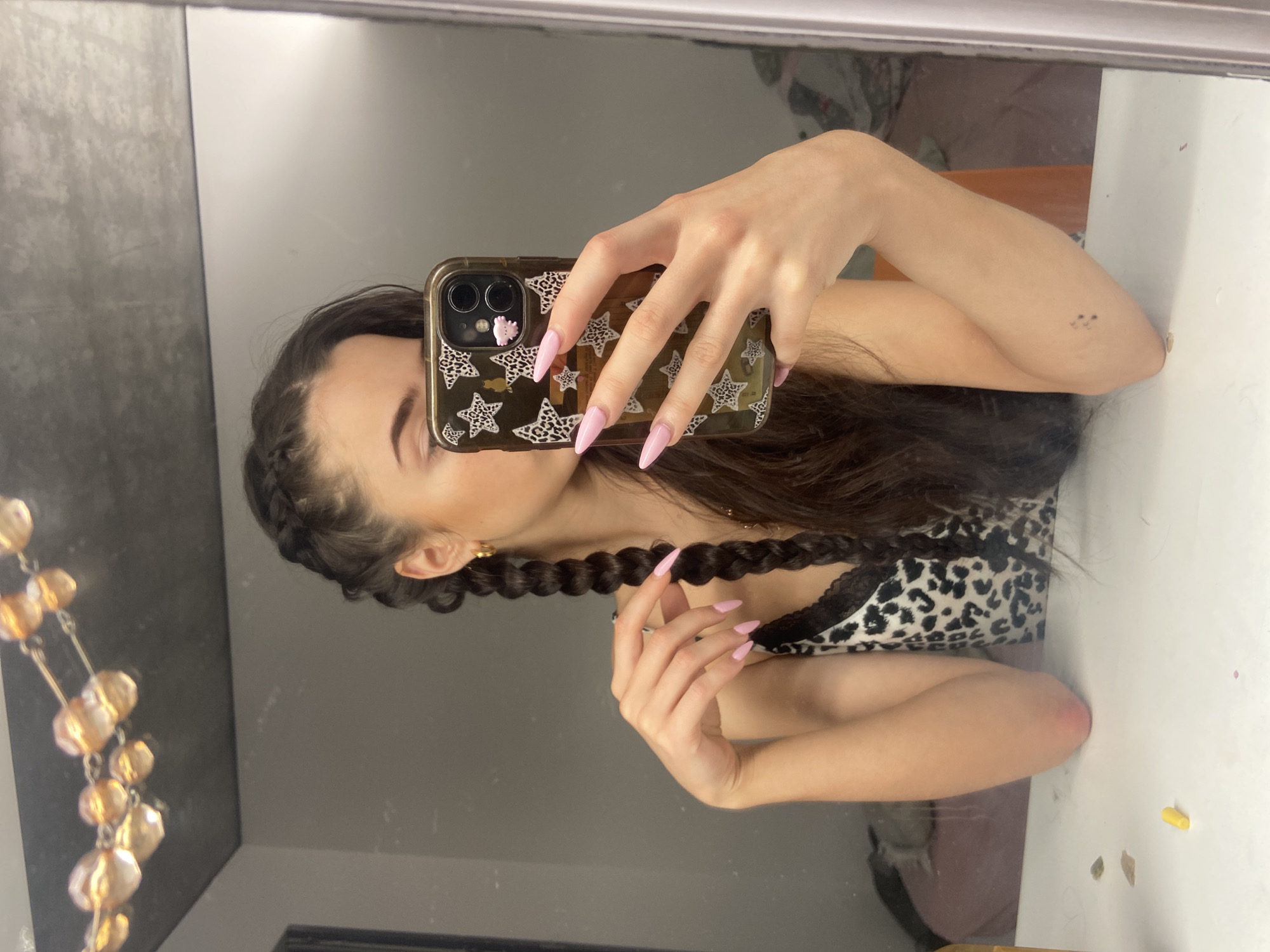 Woman takes mirror selfie in leopard print top, London