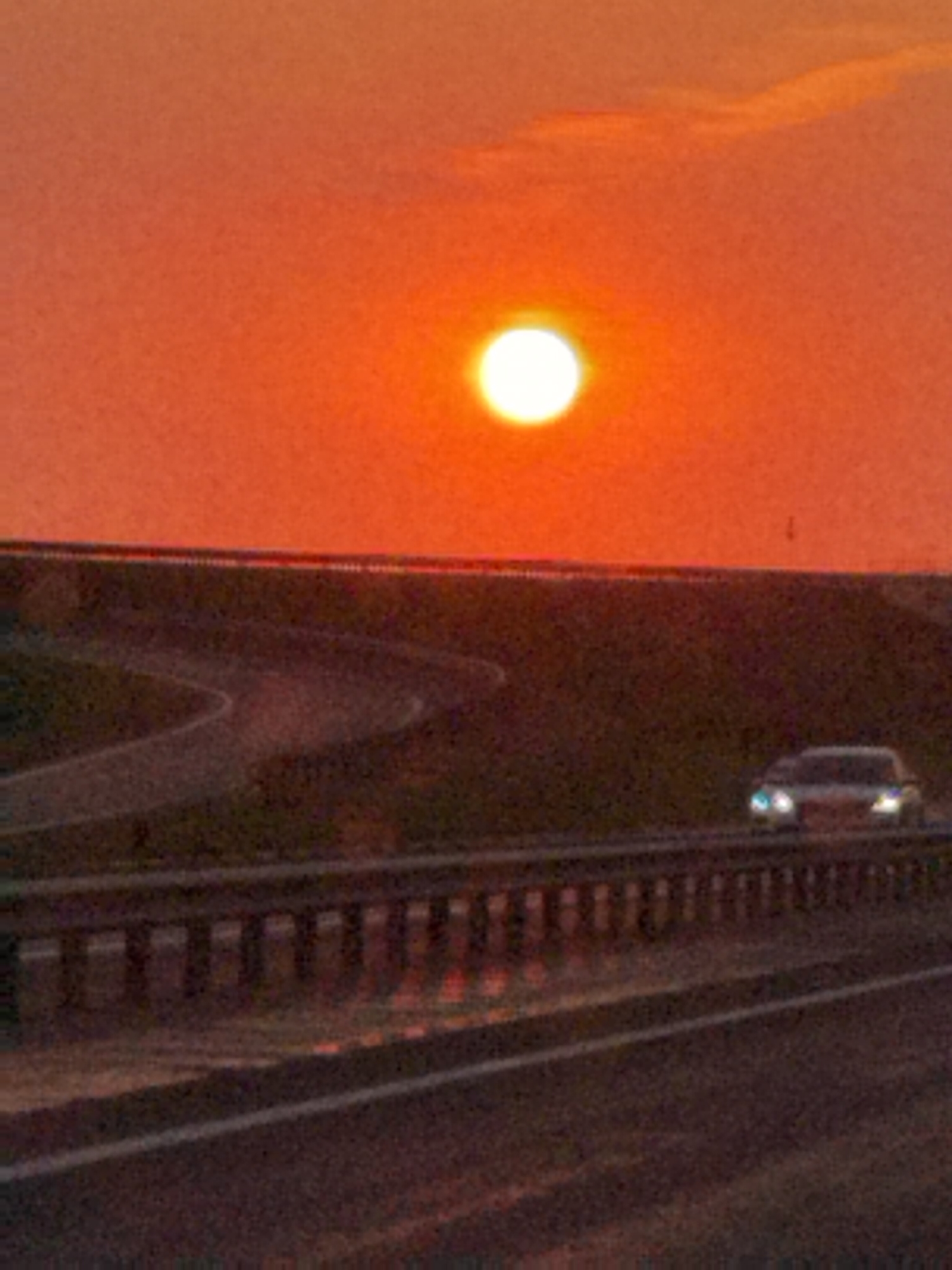 Warm sunset over a Belarusian highway at dusk