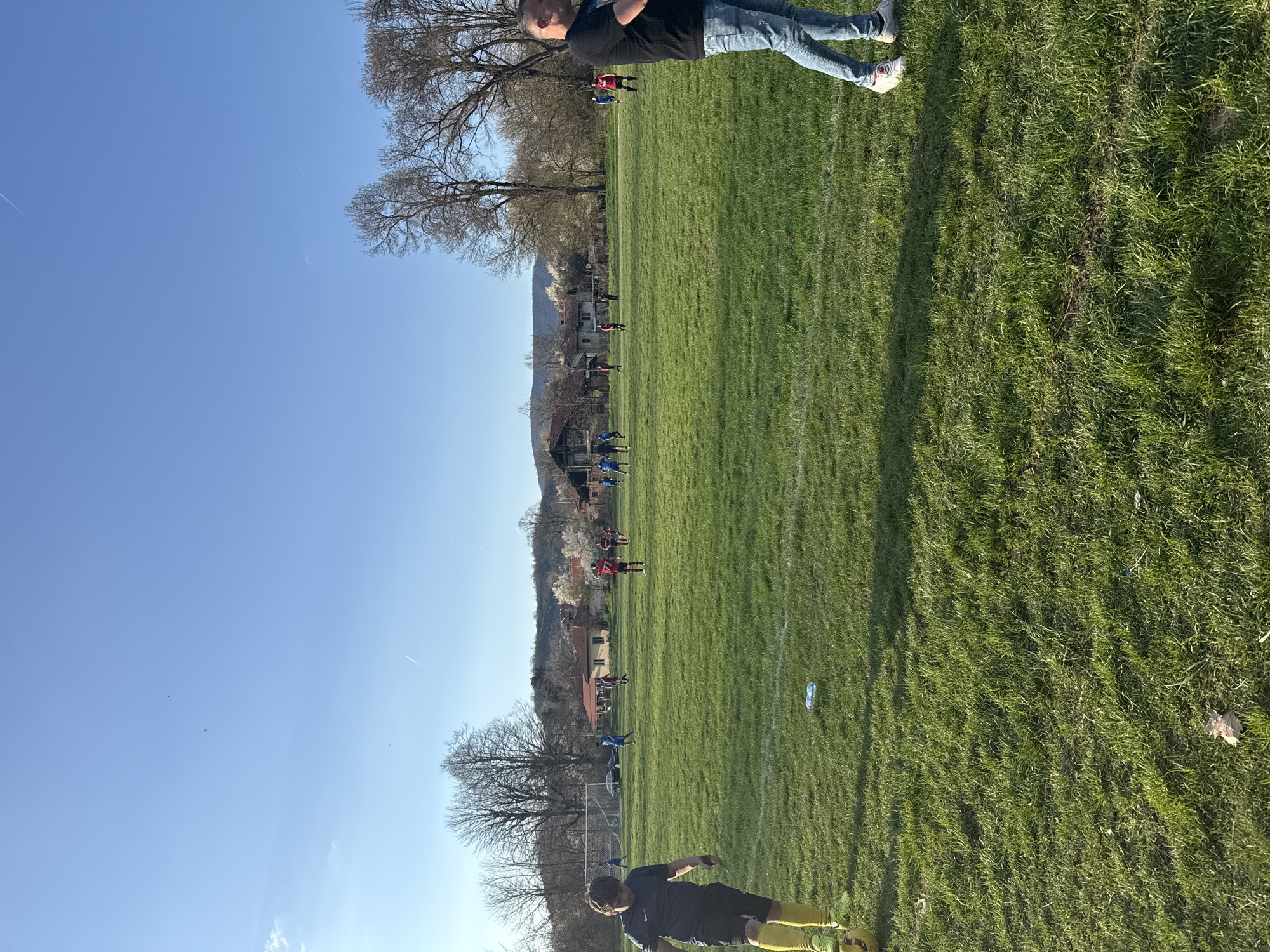 Soccer match unfolds in Dushevo, Bulgaria under sunny skies