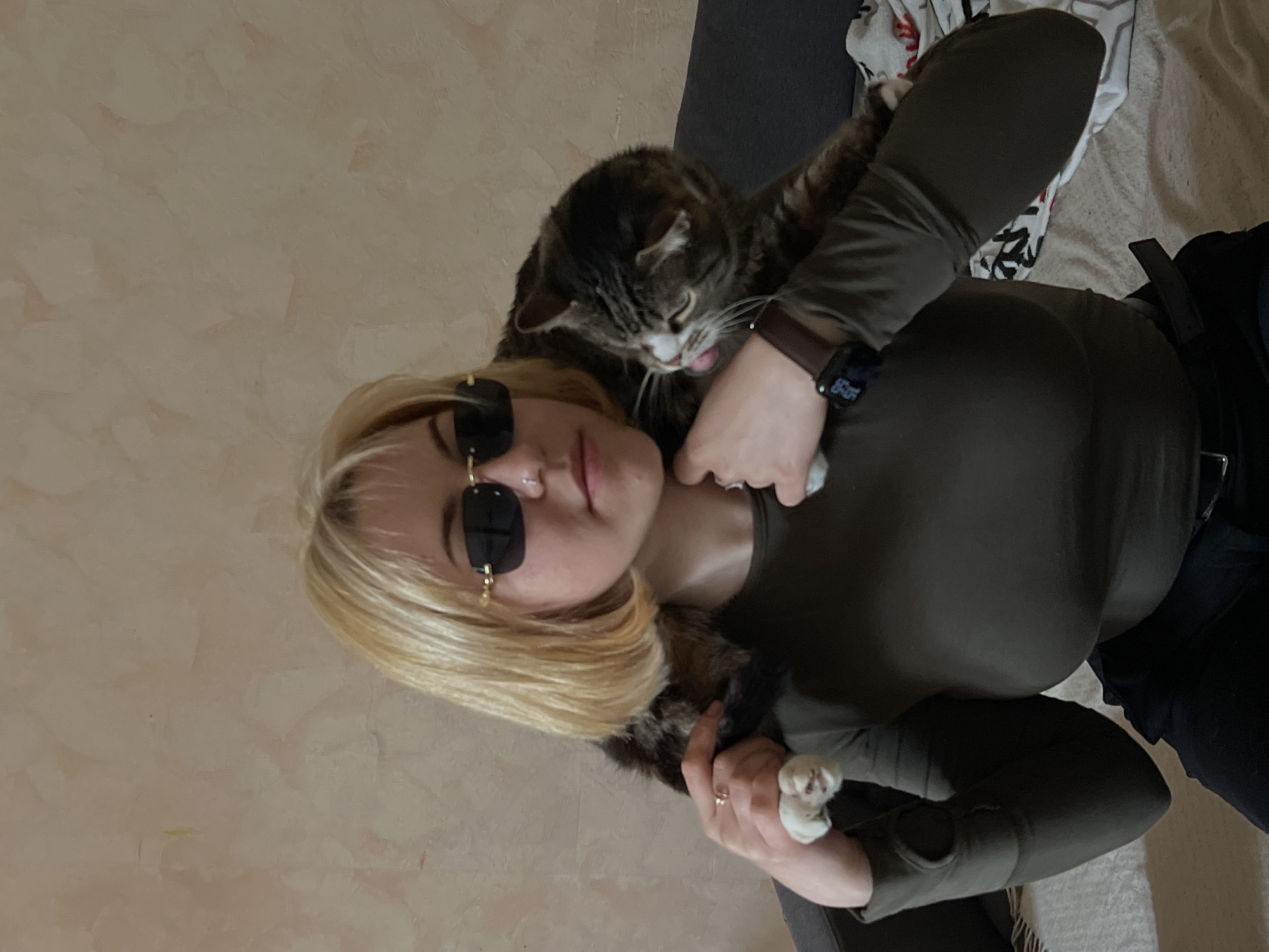 Person photographed with pets in indoor Odesa setting