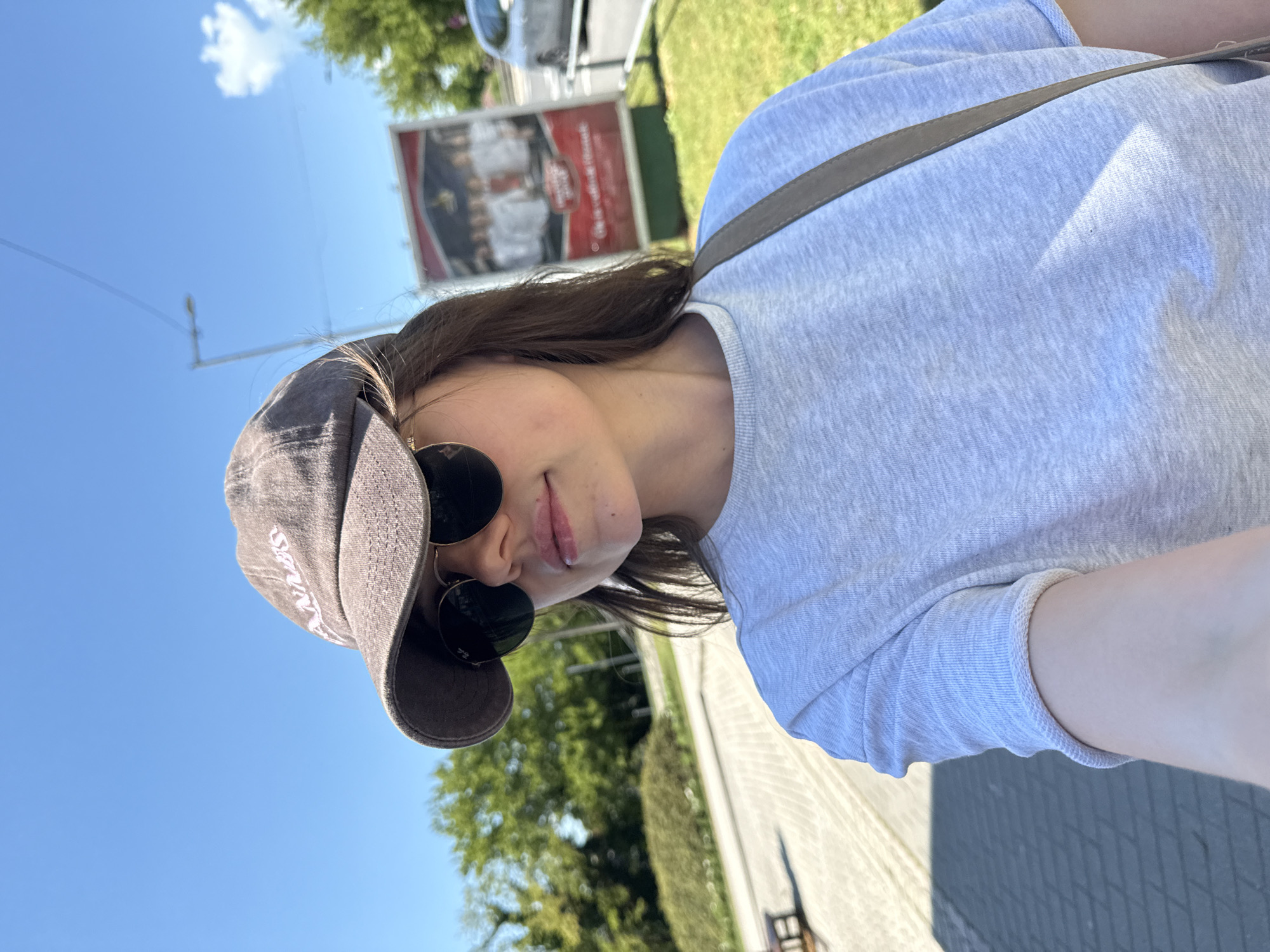 Woman takes selfie near adult shop in Siófok, Hungary