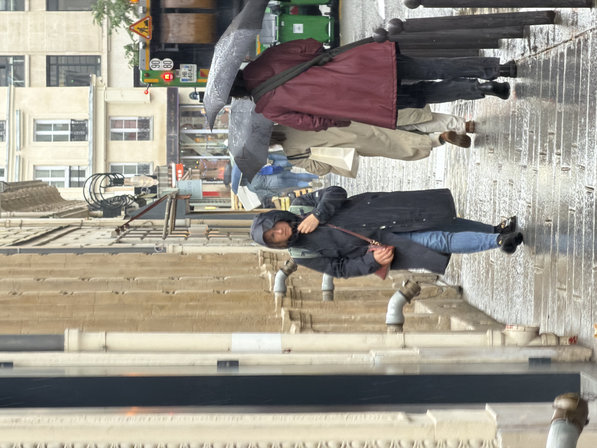 Rainy afternoon street life documented across central Paris