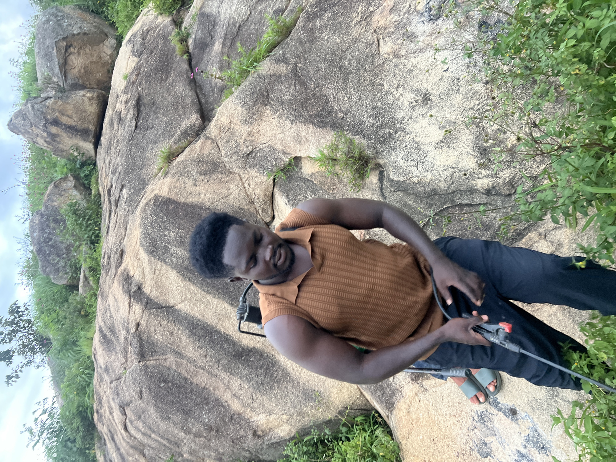 Vegetation spraying on a rocky hillside in Jos, Nigeria