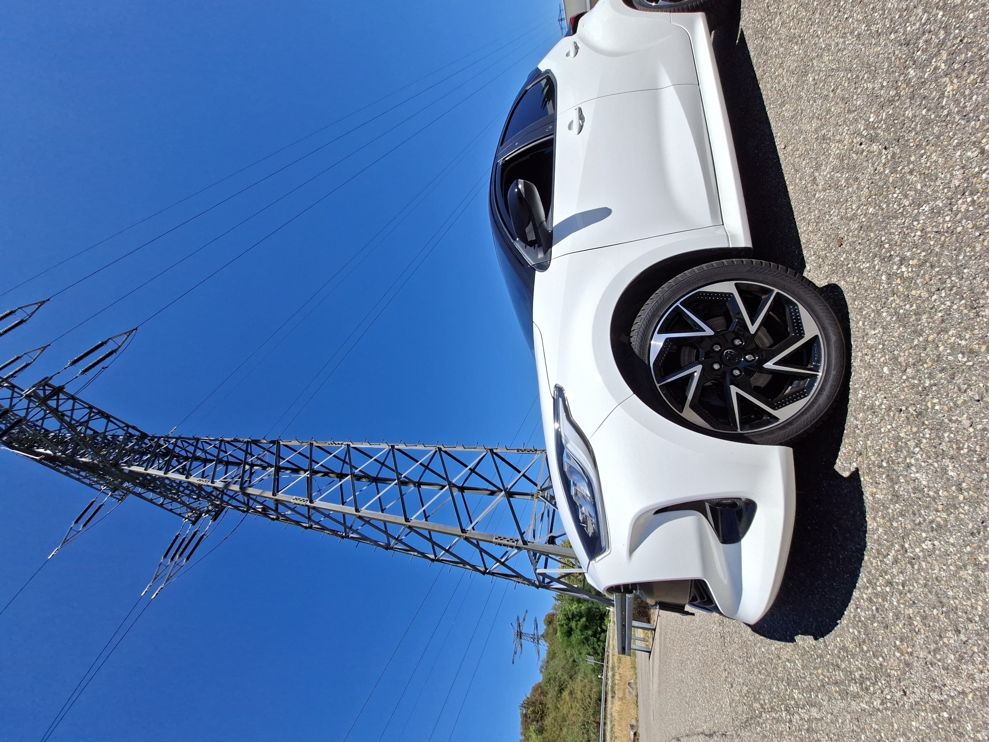 White Toyota Yaris parked under a power pylon near Baden-Baden