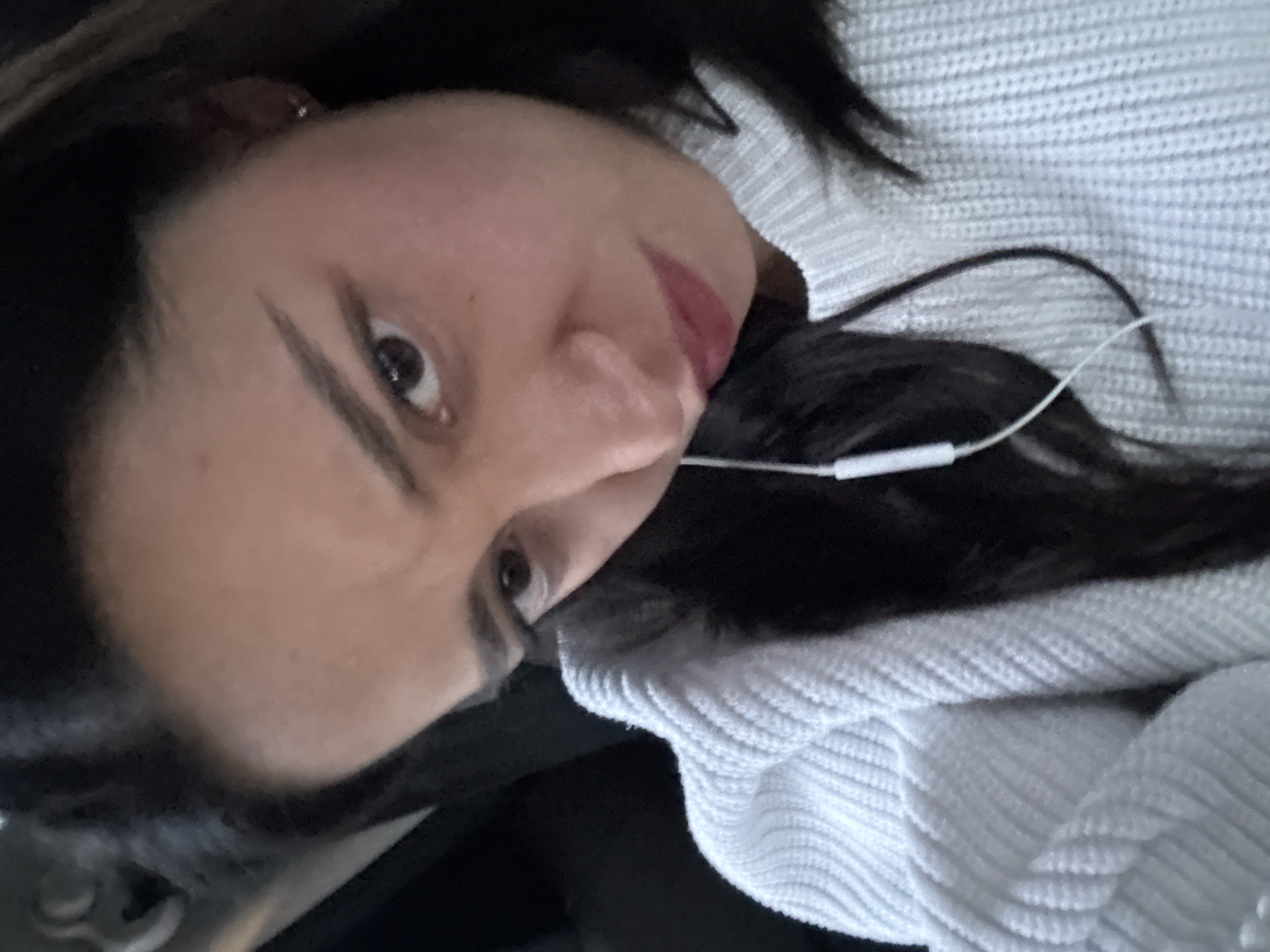 Woman in white sweater listening to music in Puebla