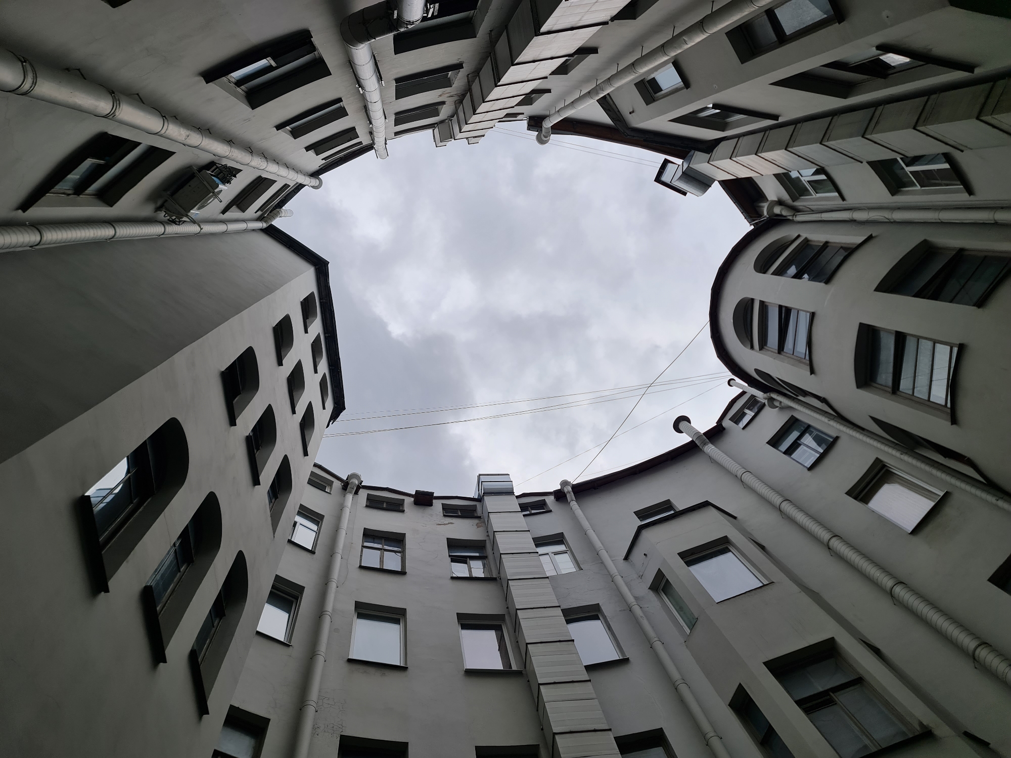 Looking up from a gray Saint Petersburg courtyard
