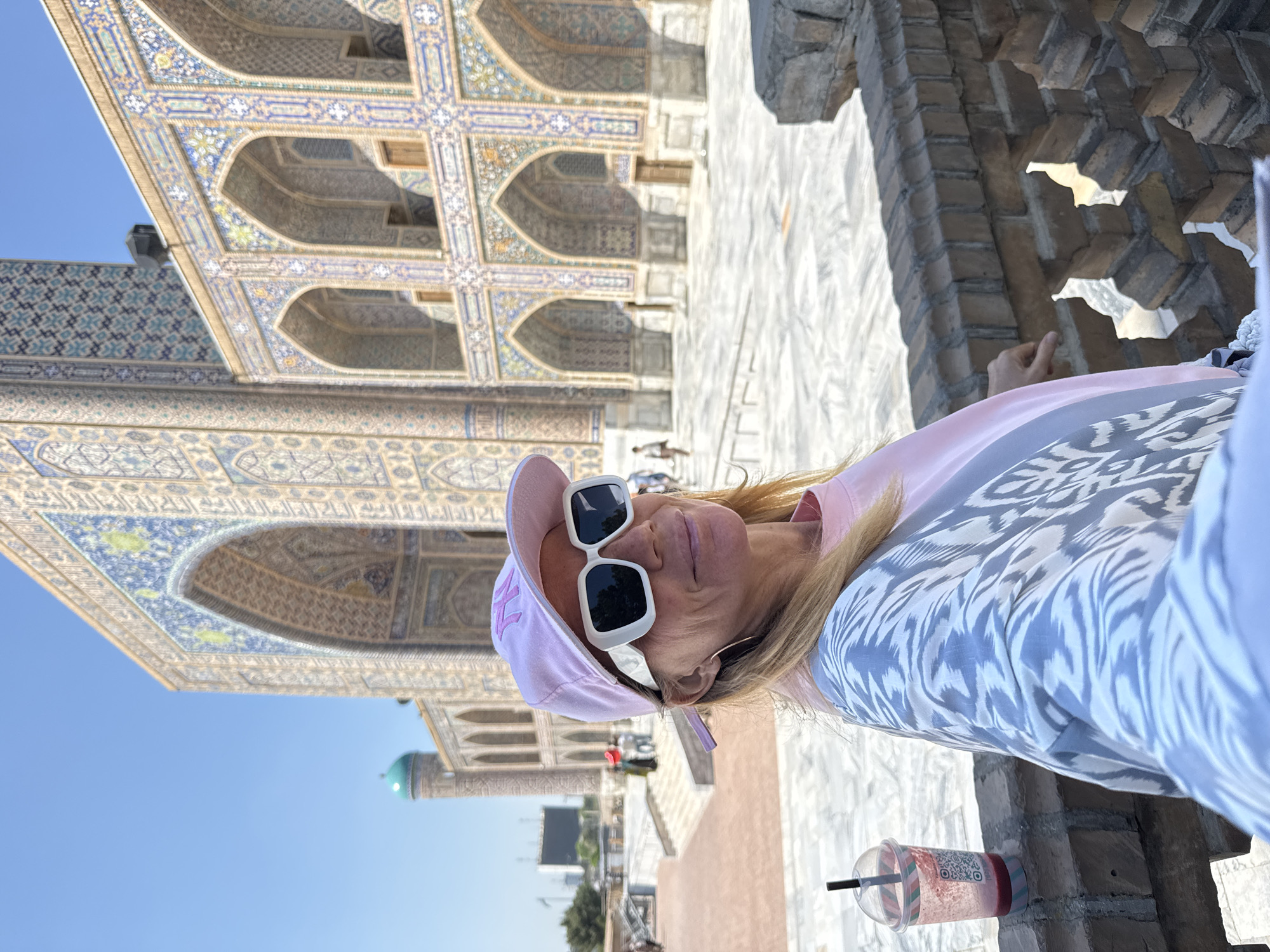 Tourist documents historic Samarkand sites and urban farm animals