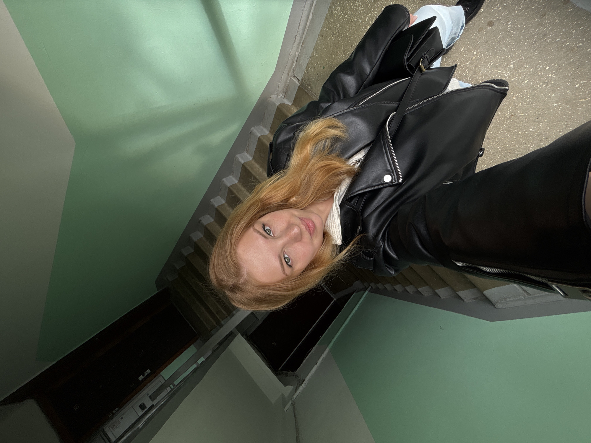 Person photographed twice in different outfits in Podosenikha building