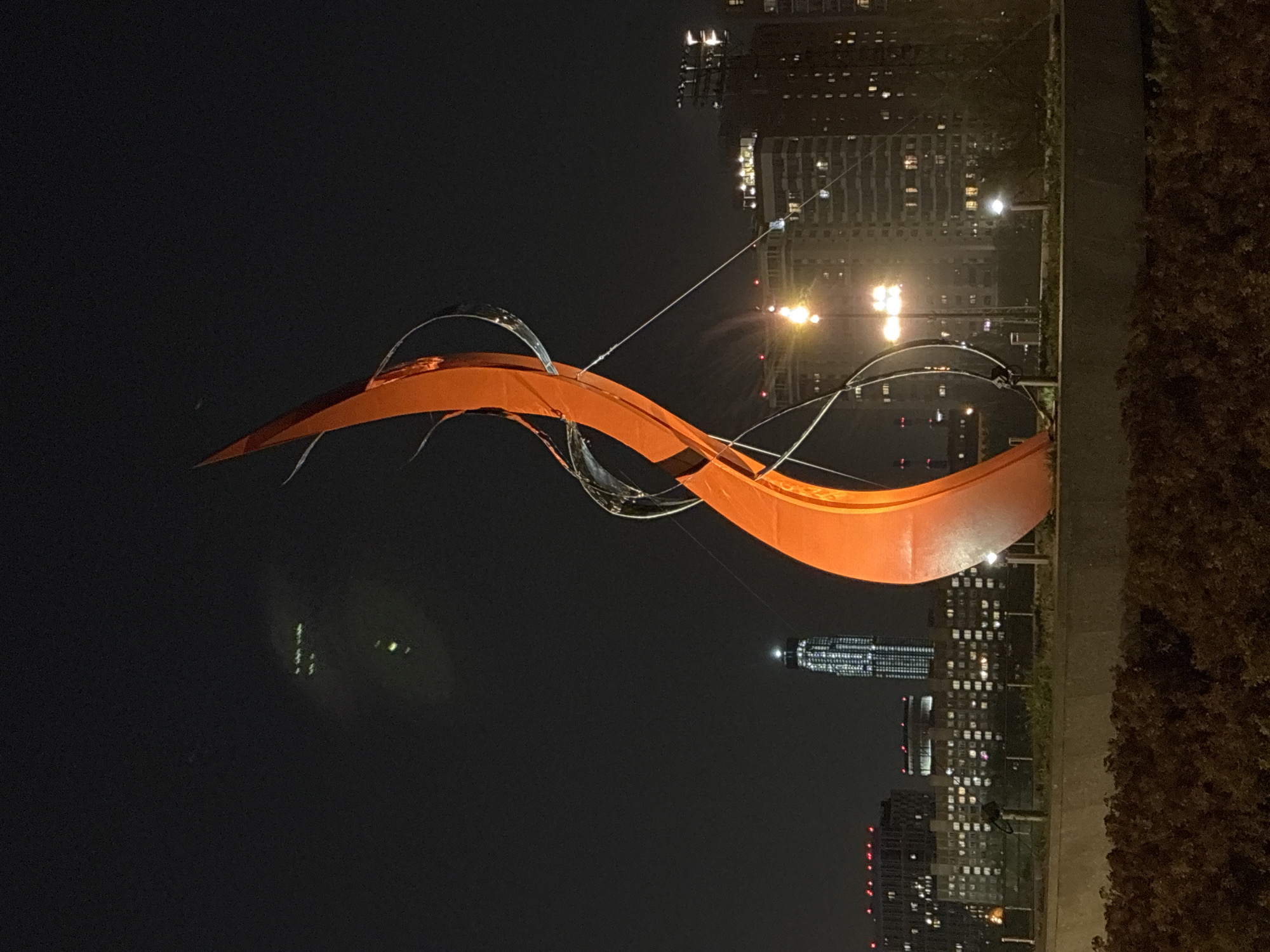 Urban night scenes: sculpture, flags, bicycle documented over 8 minutes