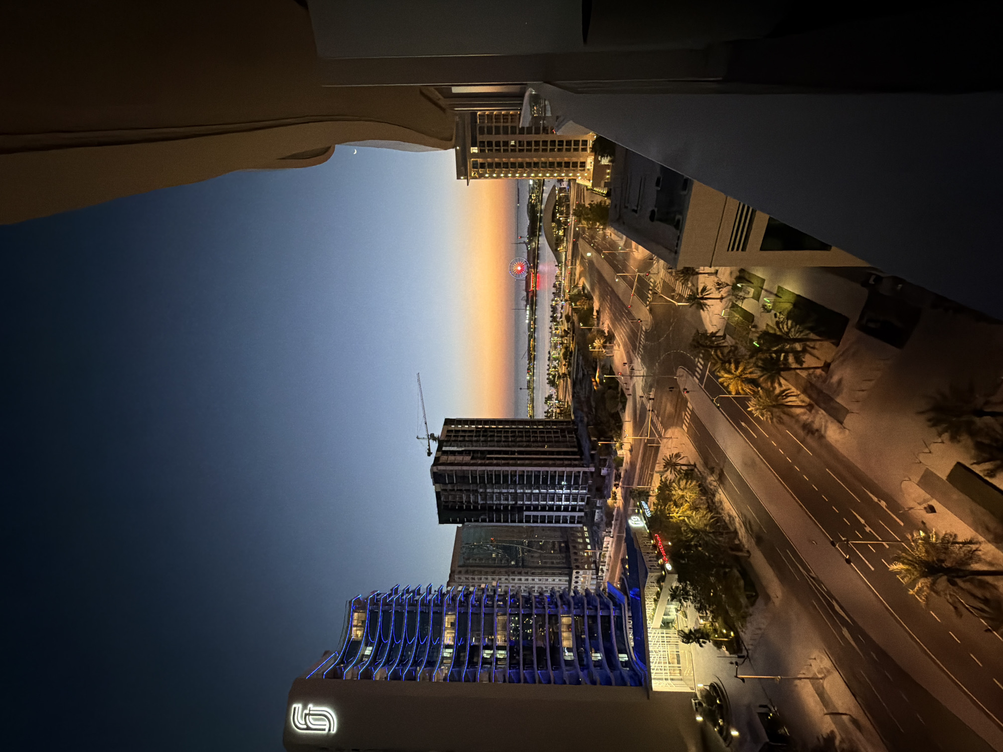 Witness documents illuminated waterfront city during dusk hours